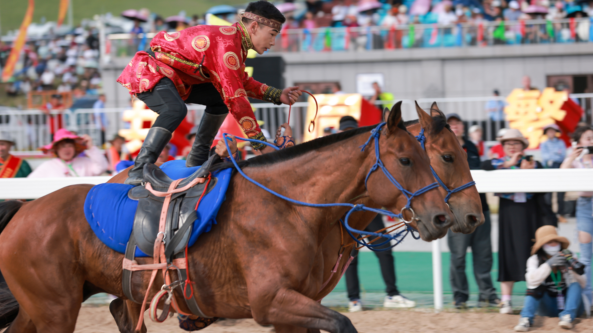 A man performs stunts on horseback during the Naadam Festival held in Hinggan League, Inner Mongolia, in 2023. /CFP
