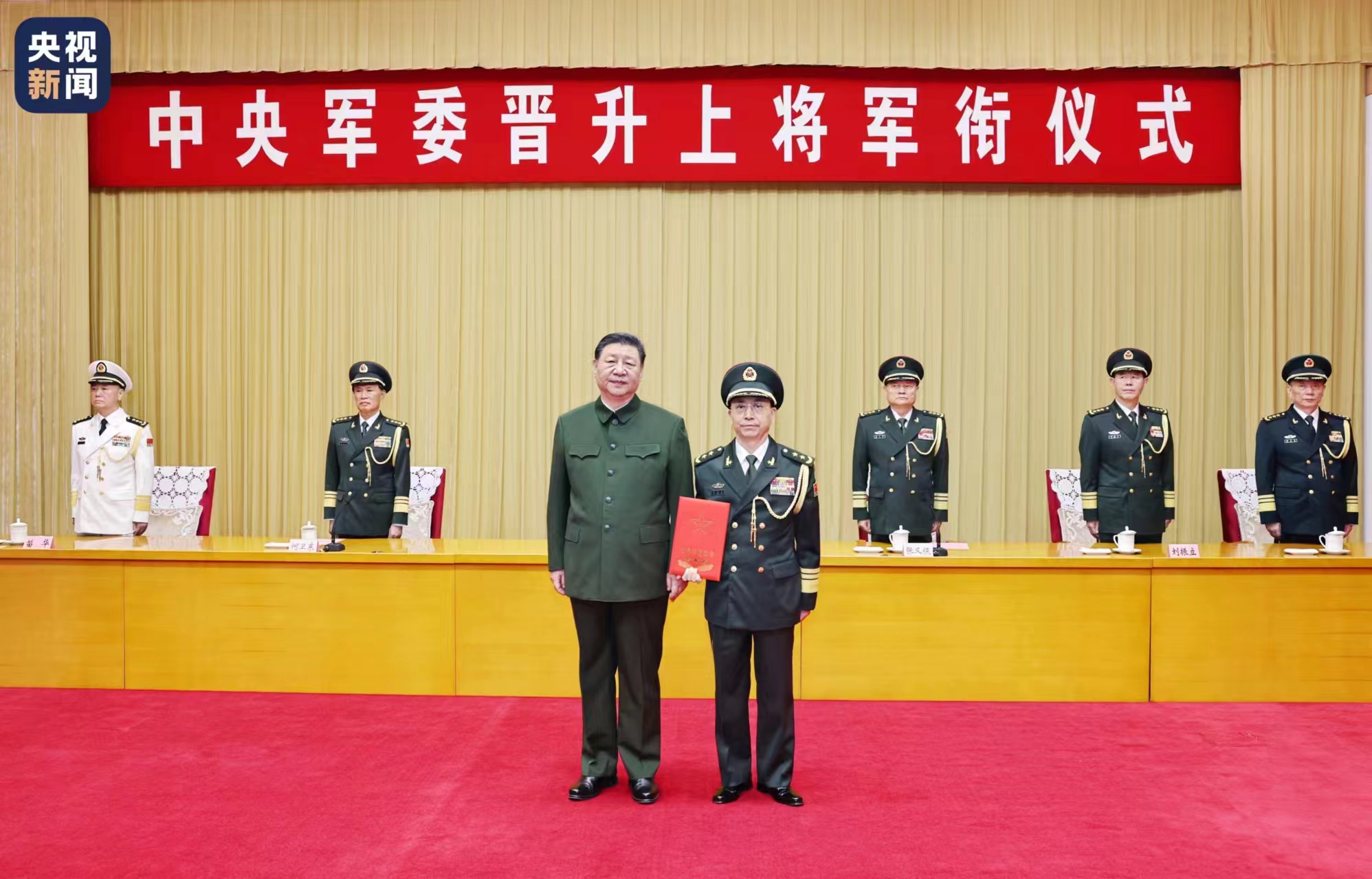 Xi Jinping, chairman of the CMC, presents a certificate of order to promote He Hongjun, executive deputy director of the Political Work Department of the CMC, to the rank of general in Beijing, China, July 9, 2024. /CMG