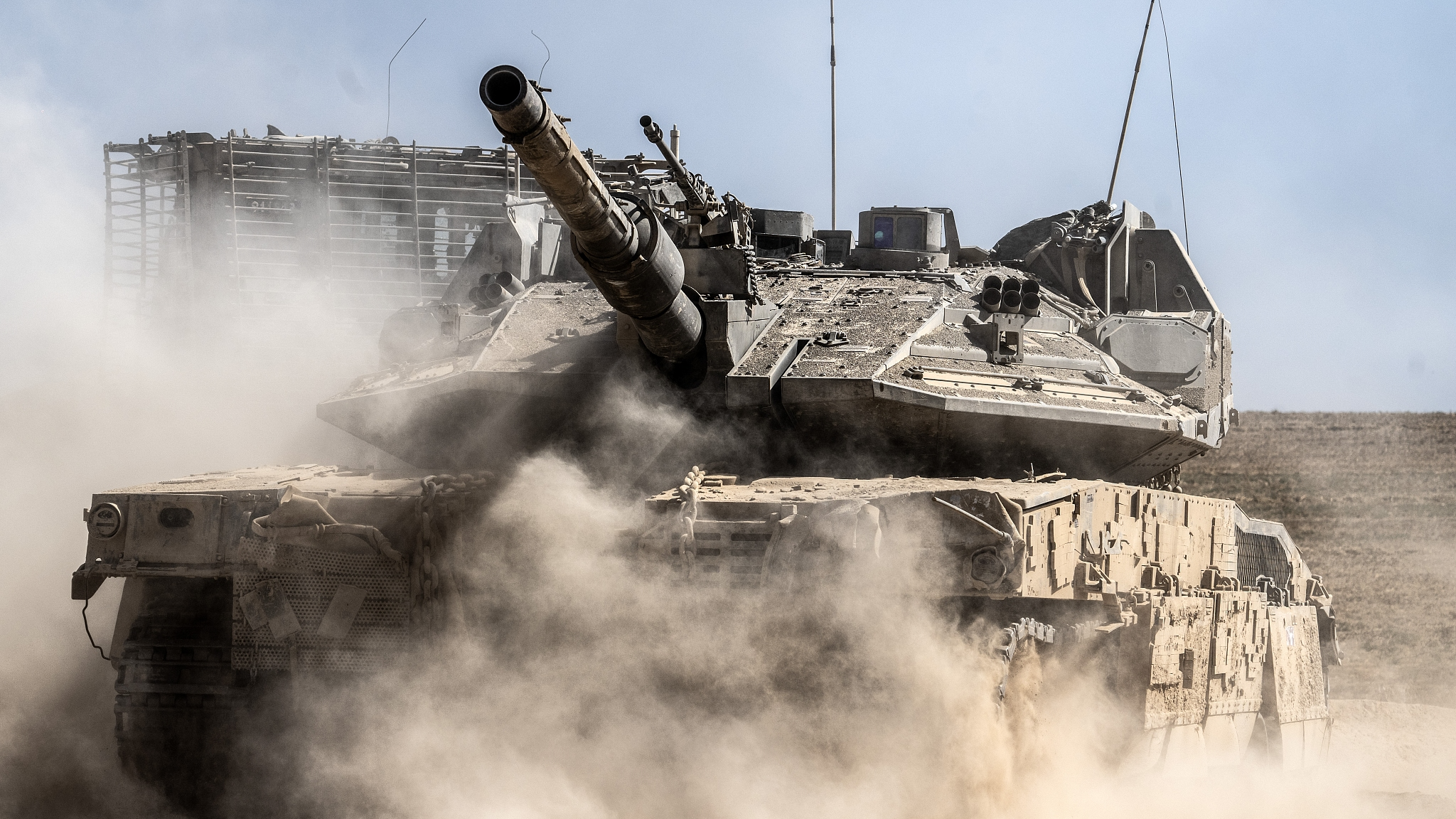Damaged tanks belonging to the Israeli army are seen being towed by tracked military vehicles from the areas close to the Israel-Gaza Strip border line, July 9, 2024. /CFP