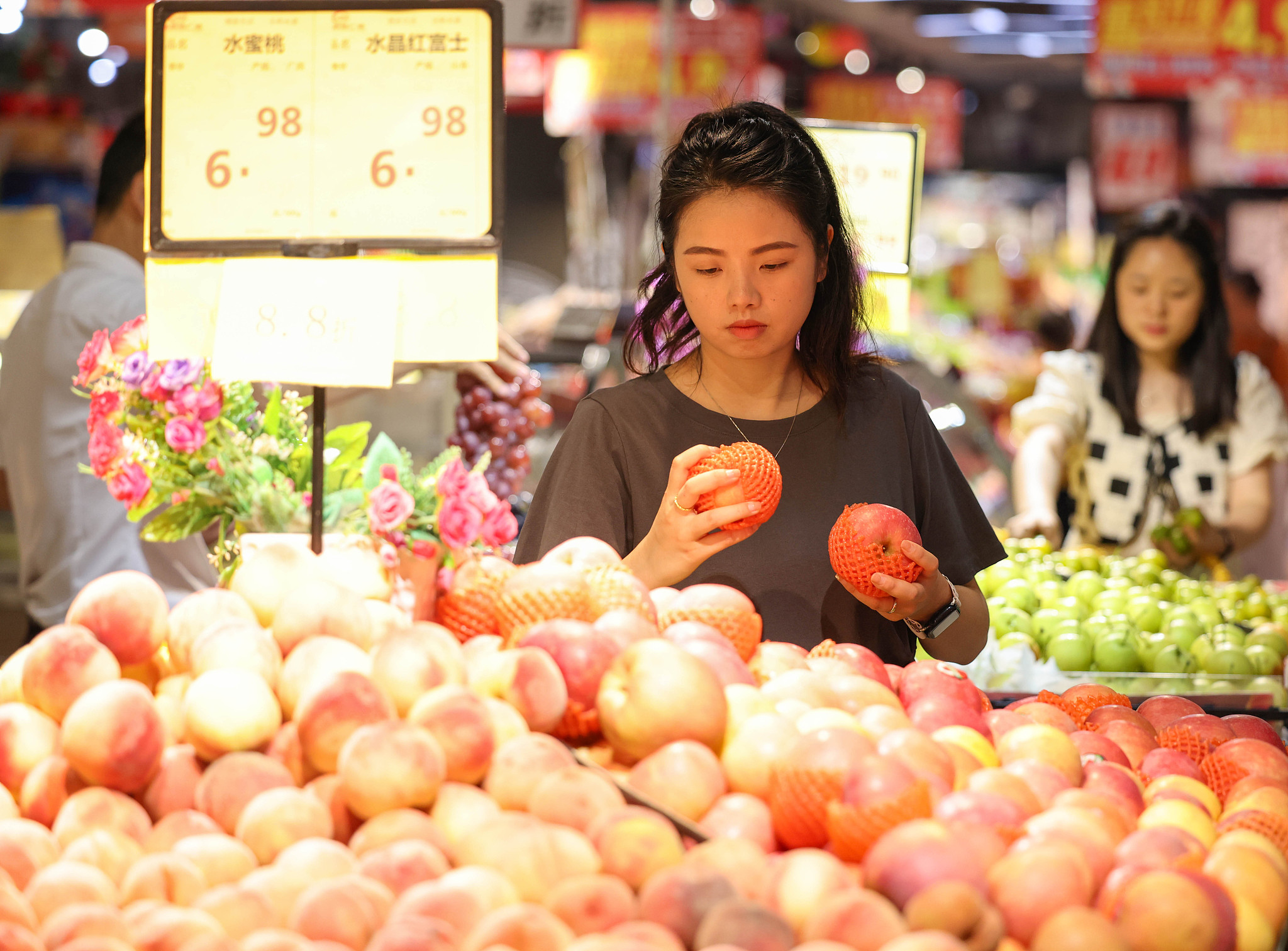 A customer looks at fruits at a supermarket in Guizhou Province, China, July 10, 2024. /CFP