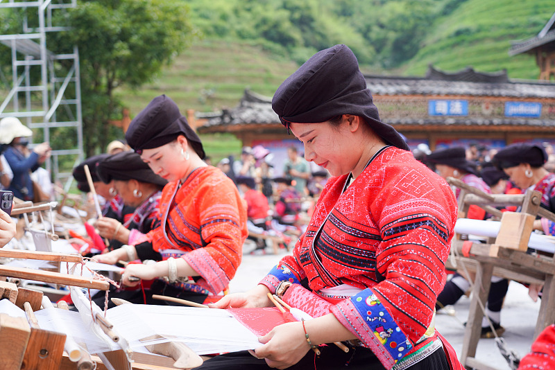 Yao women show off their embroidery skills to celebrate the Drying Clothes Festival in Guilin, Guangxi. /CFP