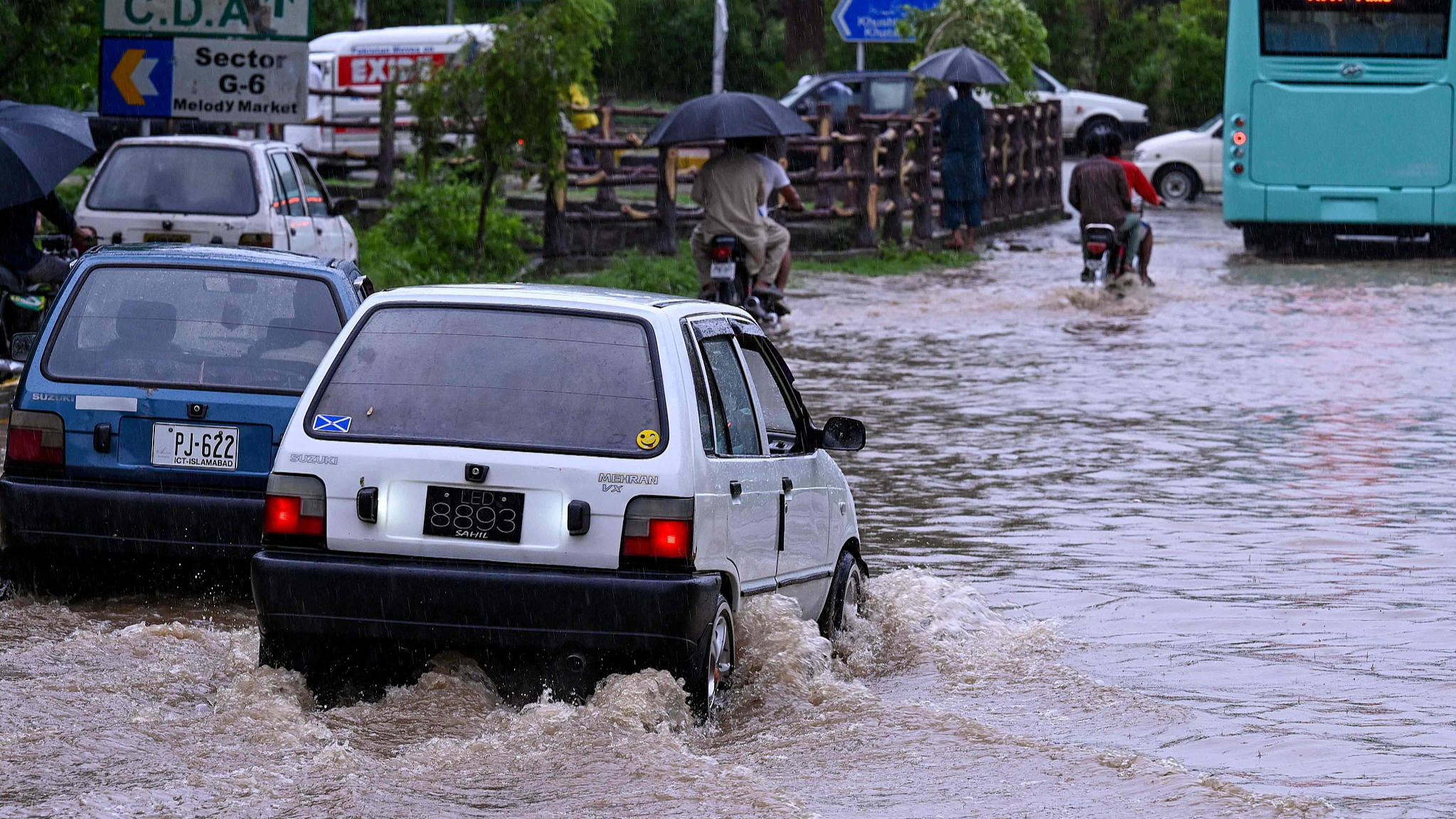 Commuters drive across a flooded street after heavy monsoon rains in Islamabad, Pakistan, July 10, 2024. /CFP