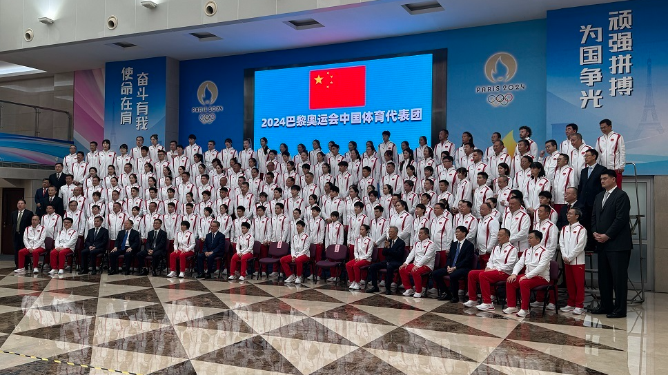 Representatives of the 716-member Team China delegation pose for a photo in Beijing, China. /CMG