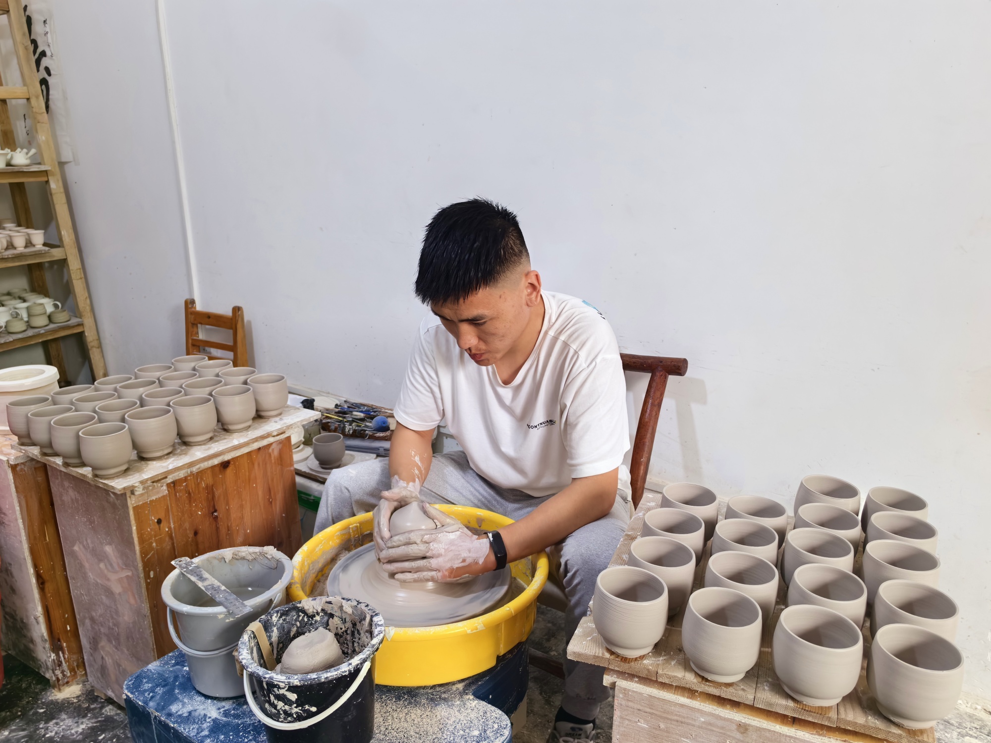 A man makes porcelain at Jinquan Porcelain Cultural Center in Sanhe Village, Chongqing, on July 10, 2024. /CGTN