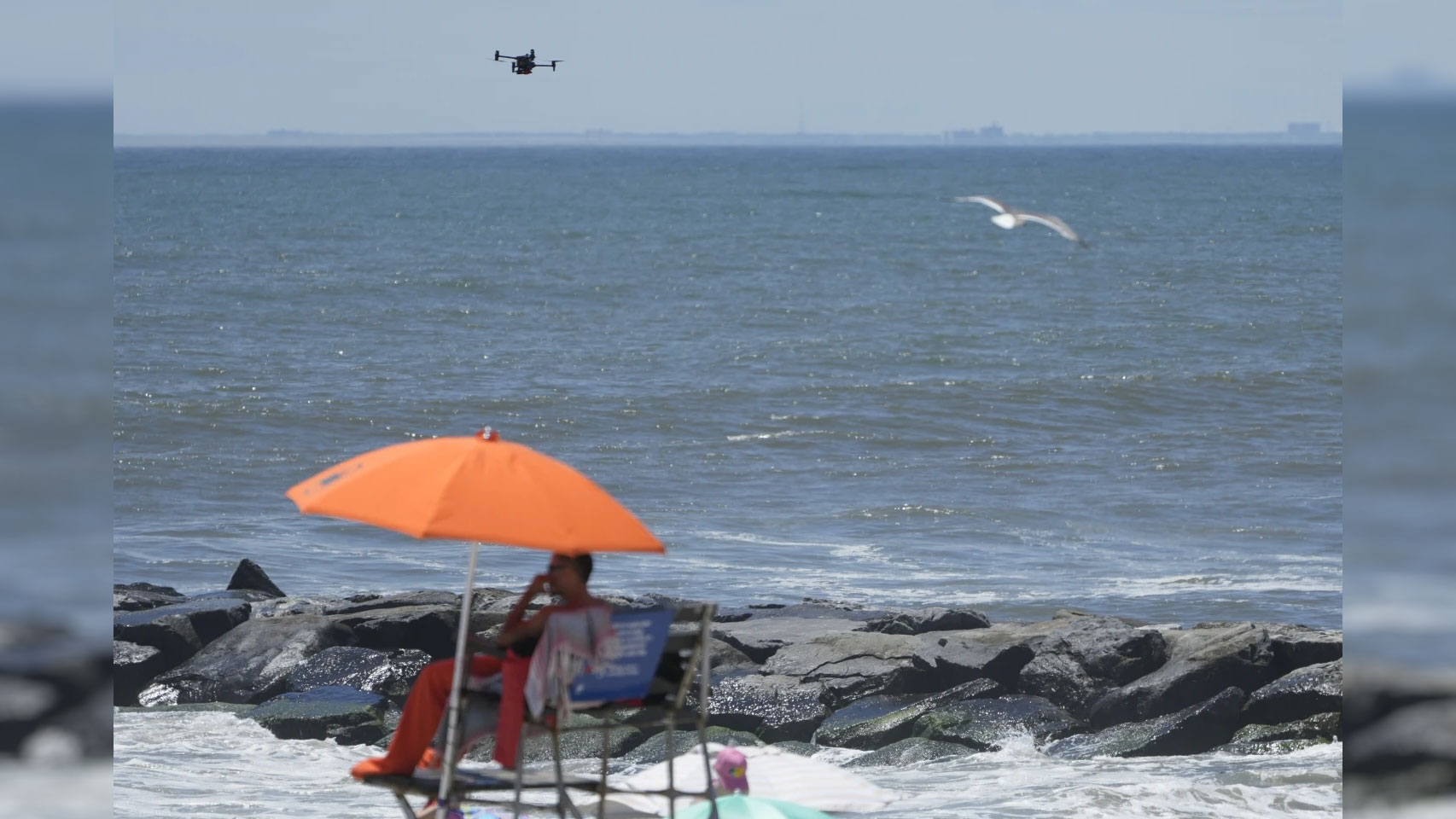 A drone scans the shoreline for signs of struggling swimmers, sharks and other hazards at Rockaway Beach in New York, U.S., July 11, 2024. /AP
