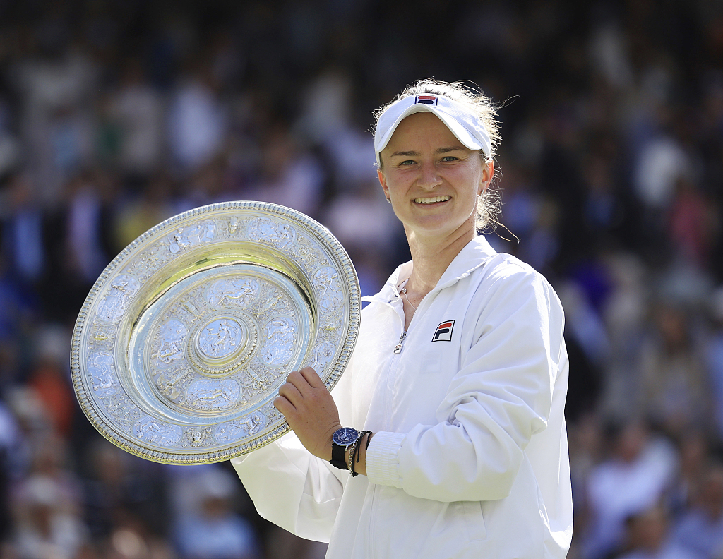 Barbora Krejcikova of the Czech Republic lifts her trophy after winning the Wimbledon women's singles title at the All England Lawn Tennis and Croquet Club in London, United Kingdom, July 13, 2024. /CFP