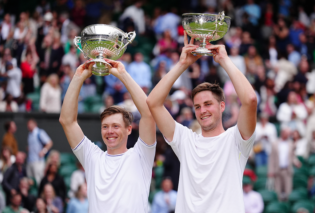 Harri Heliovaara (L) of Finland and Henry Patten of Britain raise their trophies after winning the Wimbledon men's doubles title at the All England Lawn Tennis and Croquet Club in London, United Kingdom, July 13, 2024. /CFP