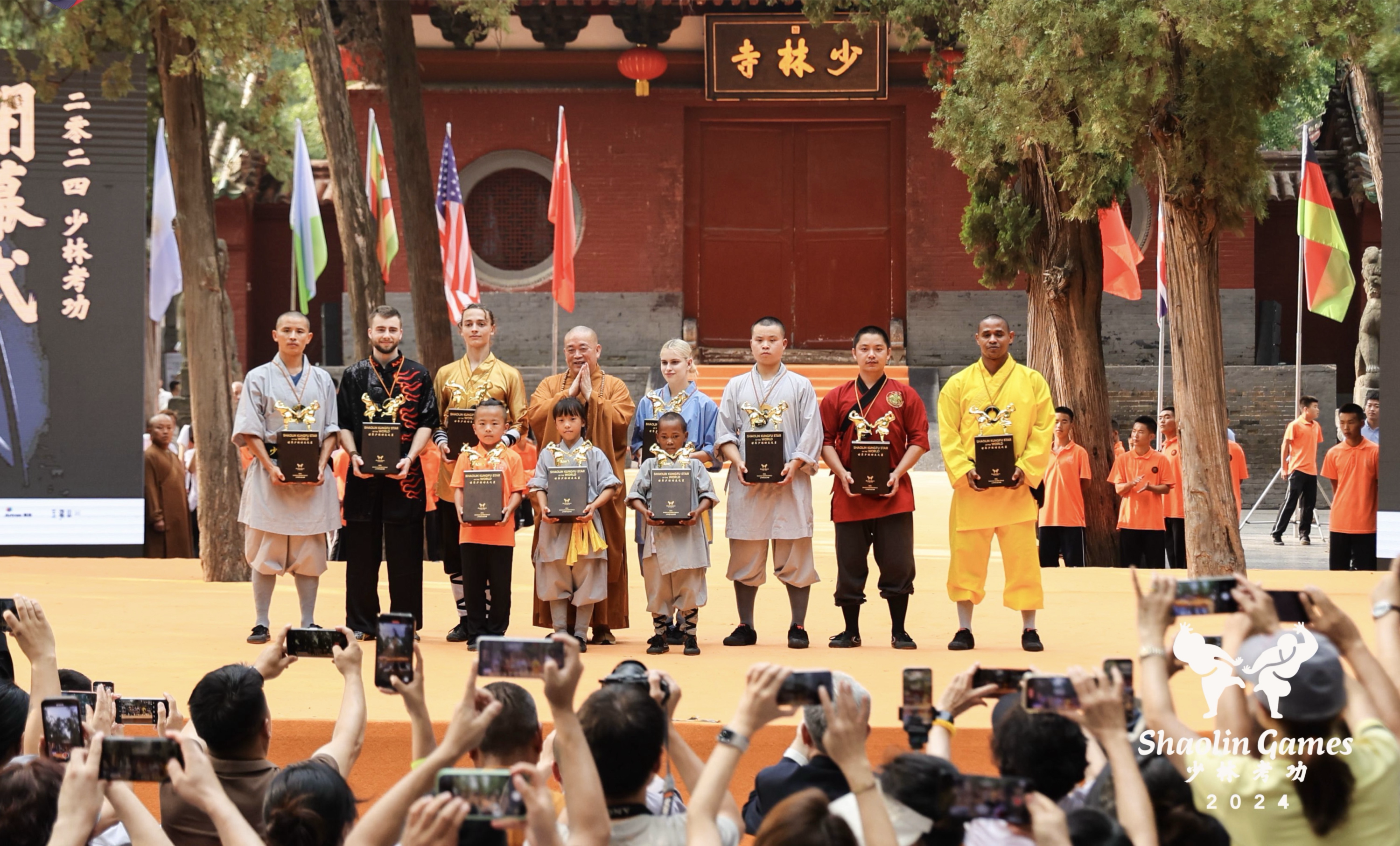 2024 World Shaolin Kung Fu Stars receive trophies and medals from Shi Yongxin, the abbot of Shaolin Temple, July 14, 2024. /CGTN