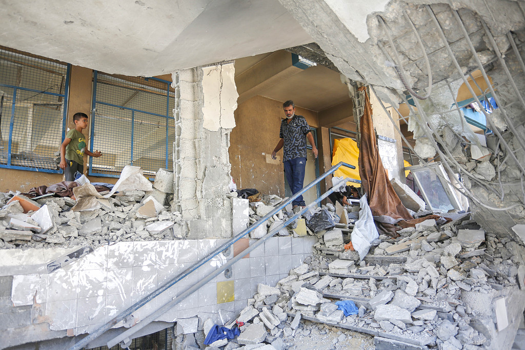 Employees of United Nations Relief and Works Agency for Palestine Refugees in the Near East (UNRWA) and Palestinians inspect a damaged school after Israeli fighter jets hit it, Deir al-Balah, Gaza, July 15, 2024. /CFP