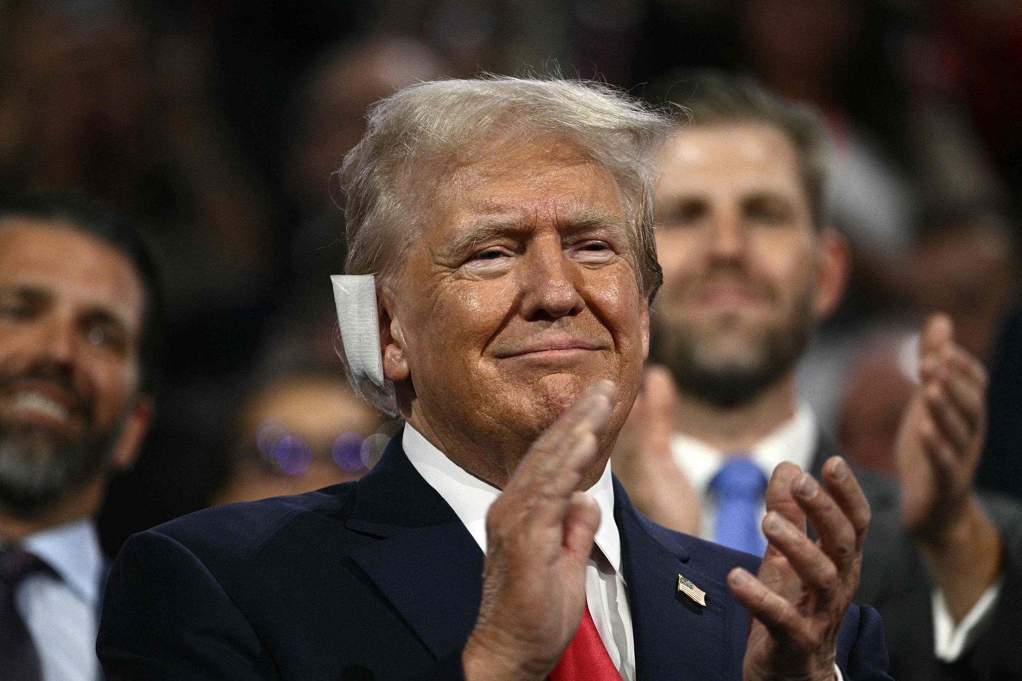 Former U.S. President and 2024 Republican presidential candidate Donald Trump with a bandage on his ear after being wounded in an assassination attempt, applauding during the first day of the 2024 Republican National Convention at the Fiserv Forum in Milwaukee, Wisconsin, July 15, 2024. /CFP