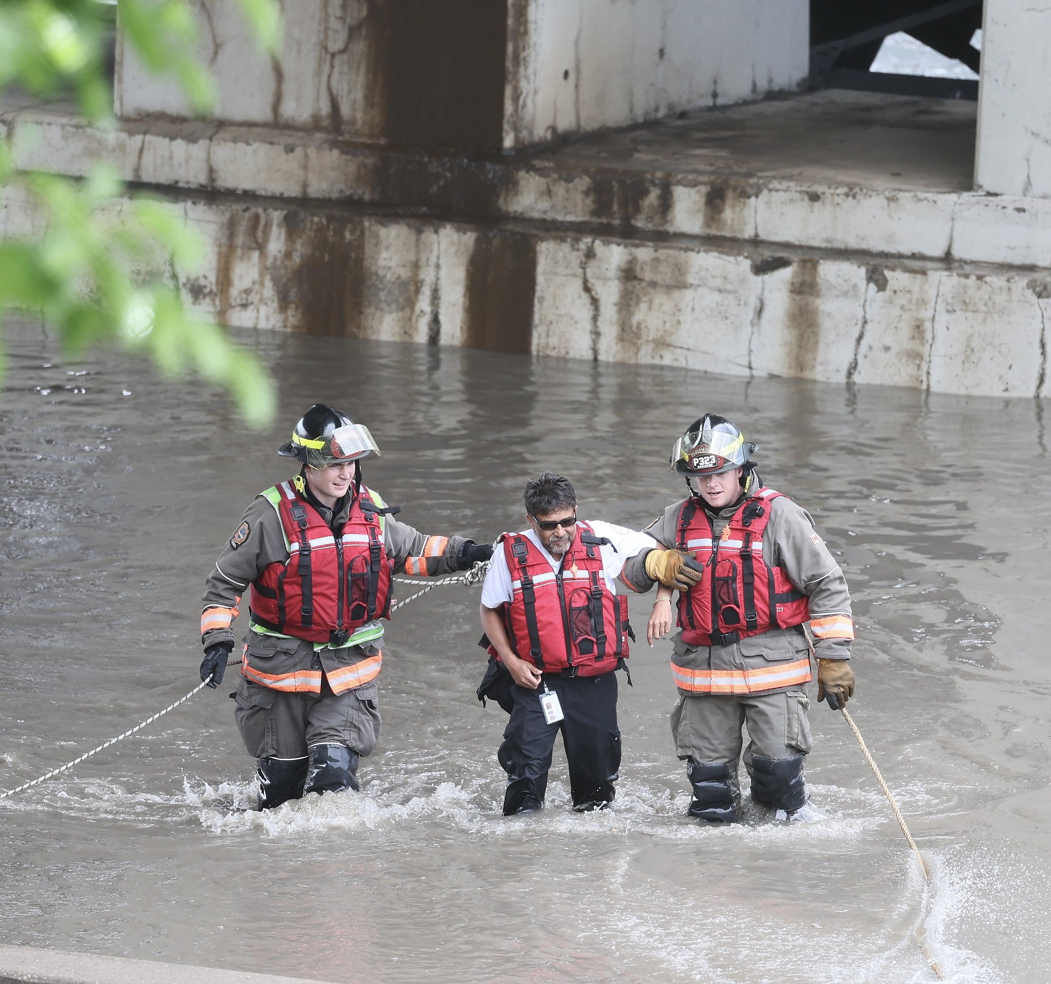 Rescuers help a man trapped on the flooded Dundas Street in Toronto, Canada, July 16, 2024. /CFP