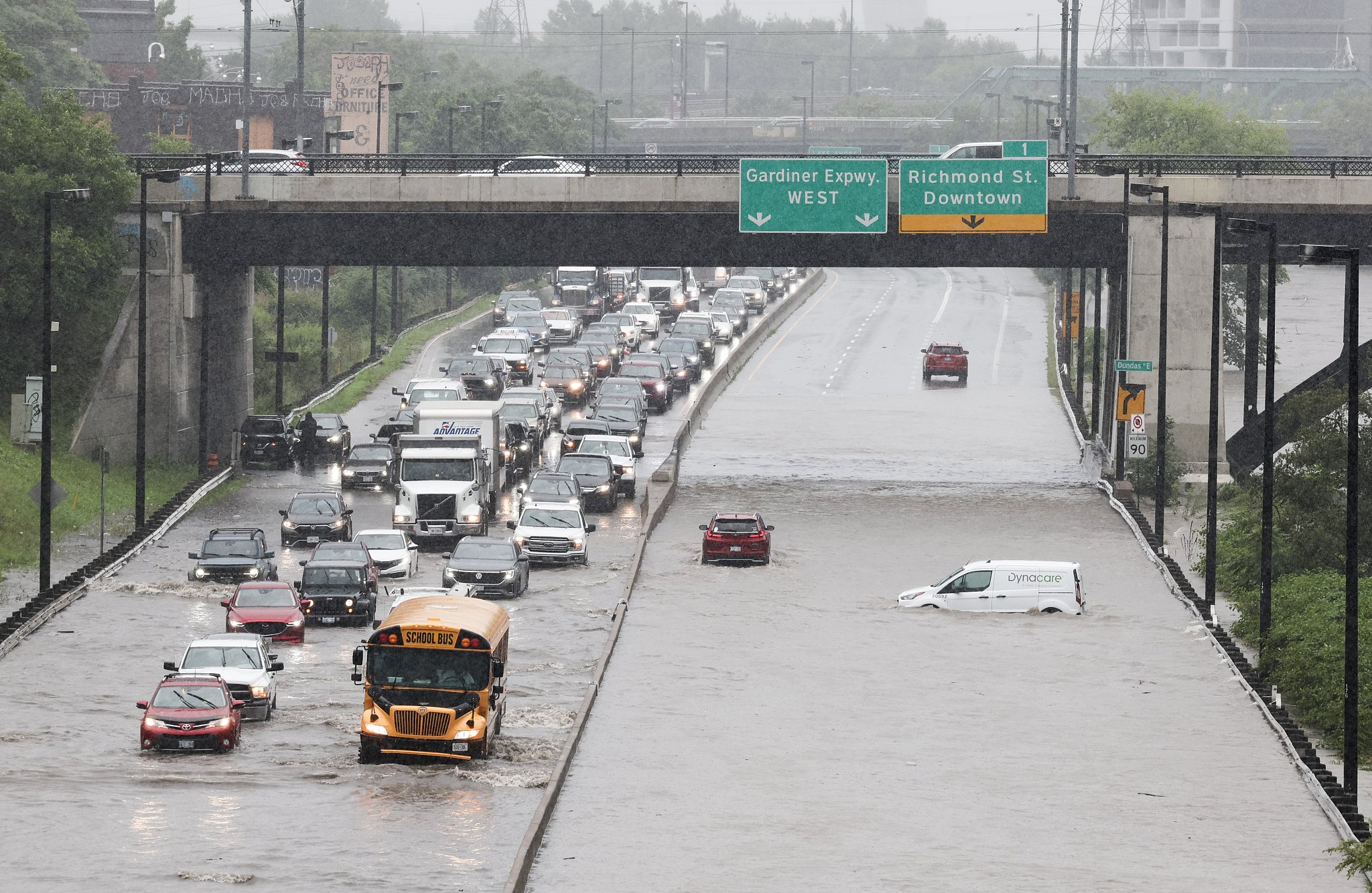 Vehicles drive on the flooded Dundas Street in Toronto, Canada, July 16, 2024. /CFP