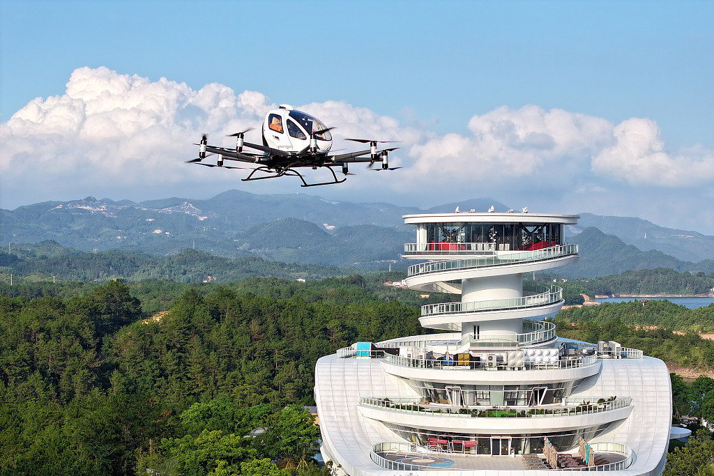 Passengers board an unmanned electric vertical take-off and landing aircraft, or eVTOL, to experience the beauty of the scenery from the air at Tianding Lake International Tourism Resort in Wencheng County, Wenzhou, Zhejiang Province, on July 16, 2024. /CFP