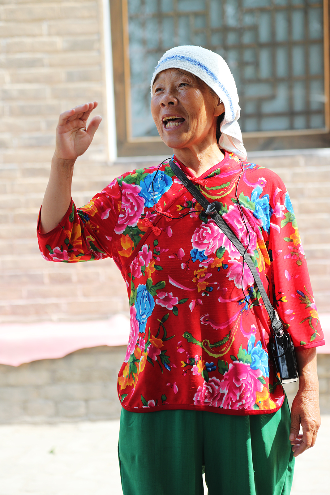 Chen Yuxiang, a resident of Lijiashan Village, welcomes visitors to her home. Chen has become an online sensation by sharing glimpses of local life on social media. /CGTN