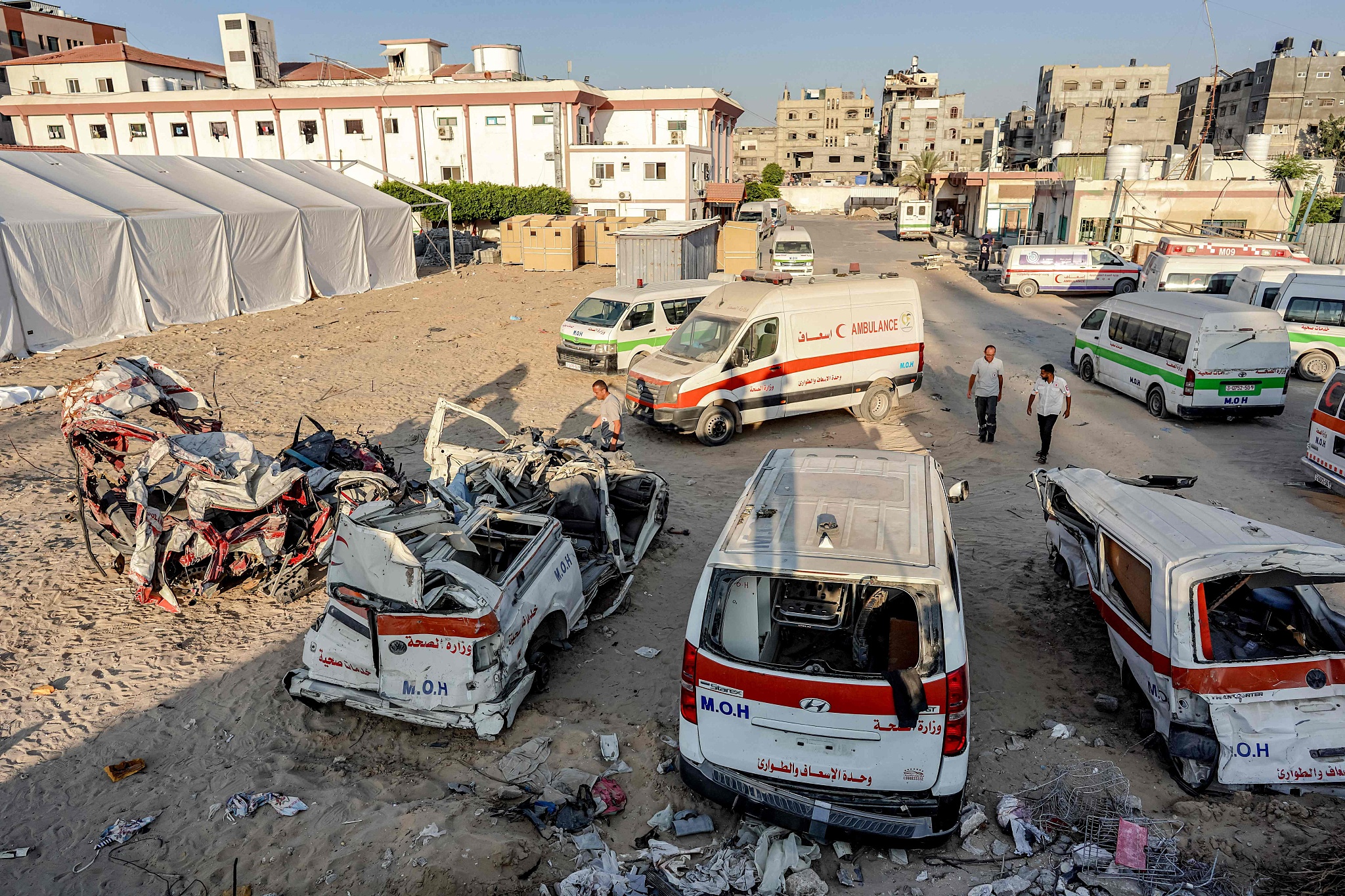 Palestinian paramedics inspect destroyed ambulances at the scene of bombardment in Khan Younis in the southern Gaza Strip, July 16, 2024. /CFP