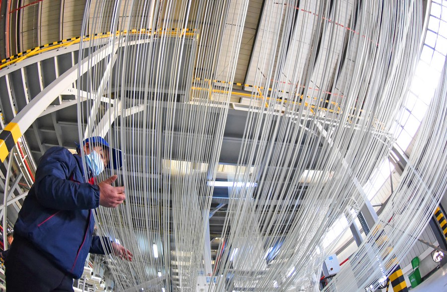 A worker checks a carbon fiber production line at the Lianyungang Economic and Technological Development Zone, east China's Jiangsu province, April 16, 2021. /Xinhua