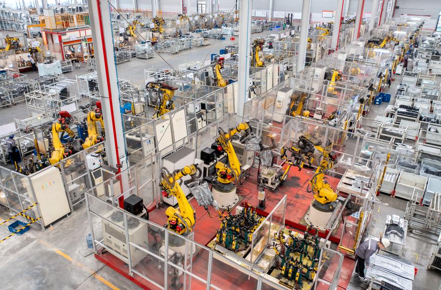 Robotic arms process parts for new energy vehicles at a private company in the Changxing Economic and Technological Development Zone, Huzhou City, east China's Zhejiang Province, January 8, 2024. /Xinhua