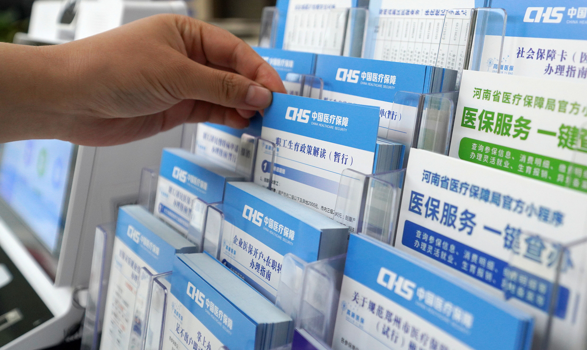 A medical insurance service promotion card in front of the service window, Zhengzhou, China, June 27, 2023. /Xinhua