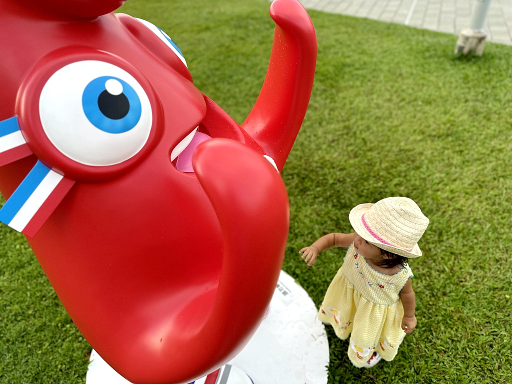 A child looks up at one of the Phryges at Tamar Park in Admiralty, Hong Kong, on July 19, 2024. /CFP