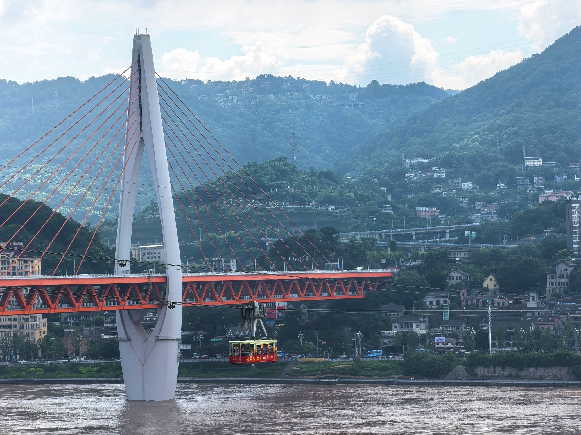 A cable car runs above the Yangtze River in Chongqing on July 12, 2024. /CGTN