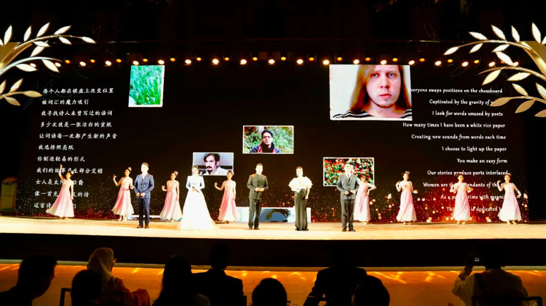 A poem appears on screen as participants take the stage to sing 