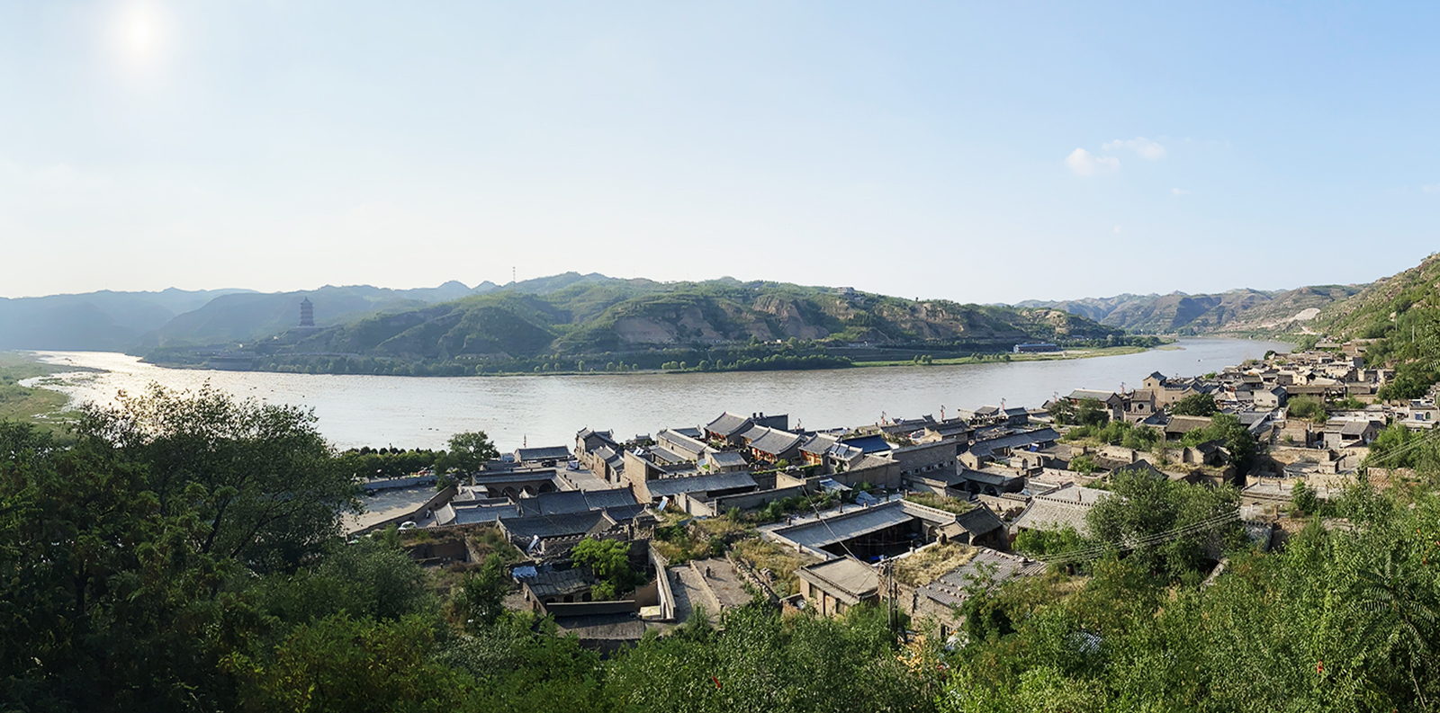 An aerial view of Qikou Ancient Town in Lvliang, Shanxi Province. Across the Yellow River lies Wubu County in neighboring Shaanxi Province. /CGTN
