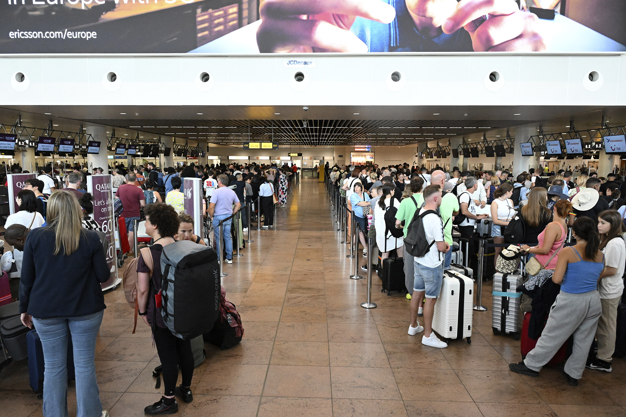 Travelers stand in a line at Brussels International Airport in Brussels, Belgium, July 19, 2024. /CFP