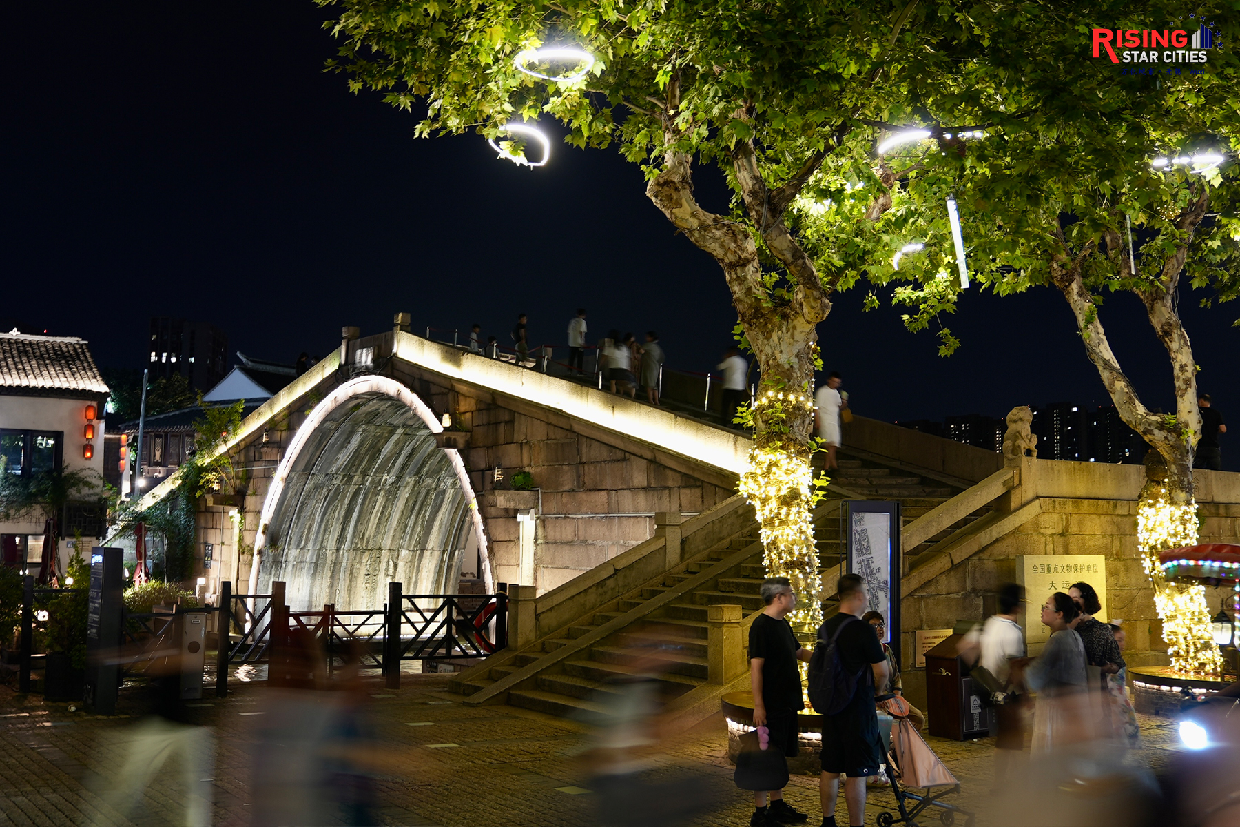 A photo taken on July 21, 2024 shows the Qingming Bridge lit up after sunset in Wuxi, Jiangsu Province. /CGTN