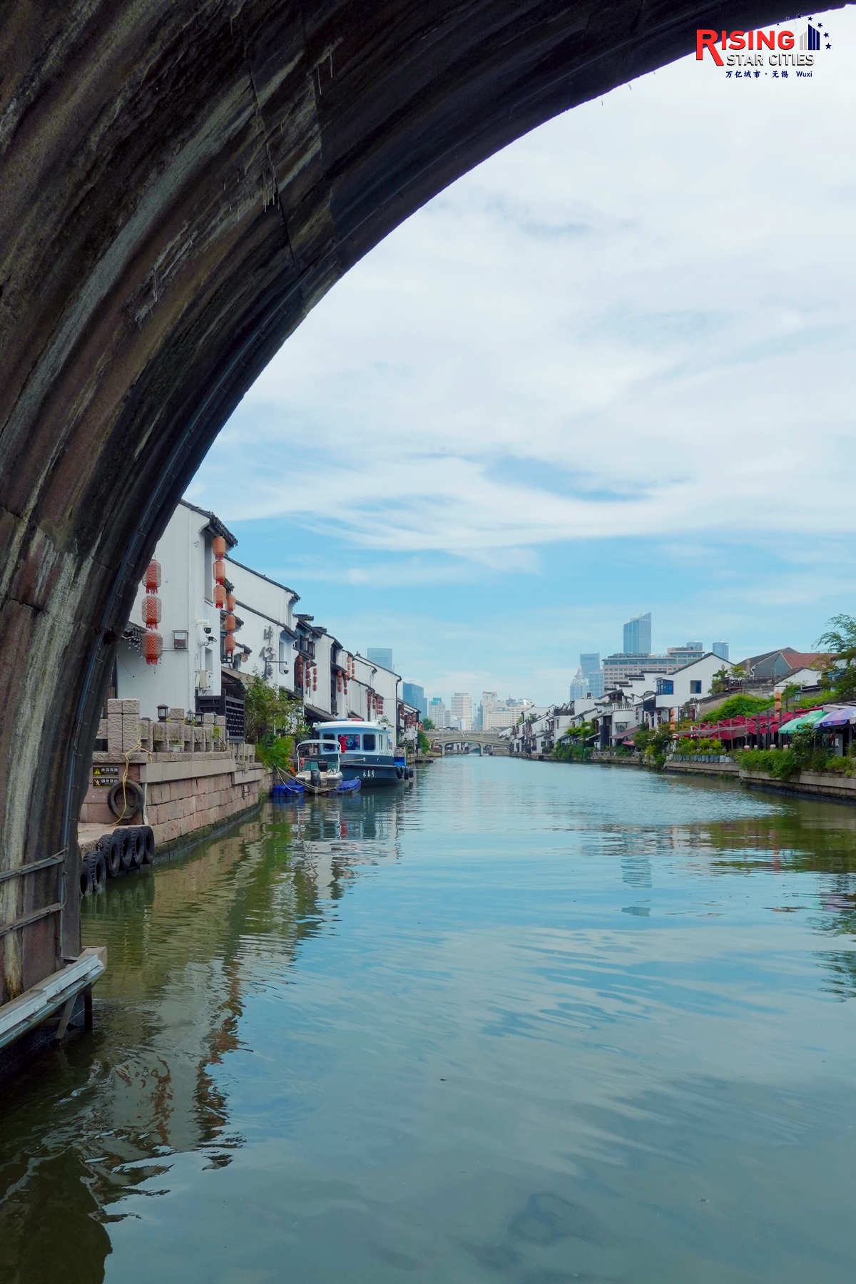 A photo taken on July 21, 2024 from under the Qingming Bridge, shows the traditional Chinese architecture lining the waterway in Wuxi, Jiangsu Province. /CGTN