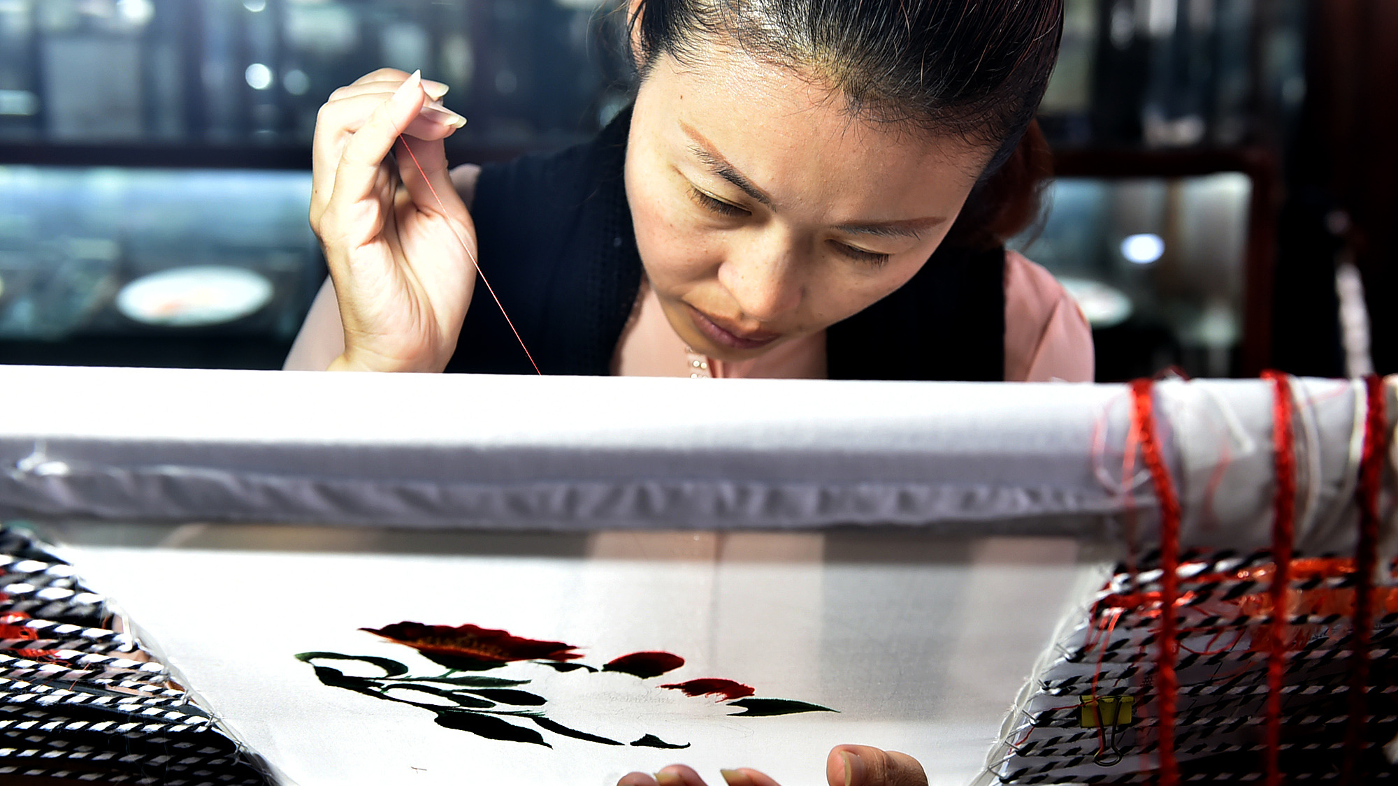 A woman weaves flowers on a piece of embroidery, Wuxi, Jiangsu Province, China, Sep 26, 2020. /CFP