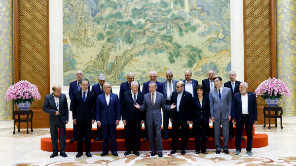 Chinese Foreign Minister Wang Yi (C, front row), also a member of the Political Bureau of the CPC Central Committee, poses for photo with representatives of Palestinian factions in Beijing, China, July 23, 2024. /Chinese Foreign Ministry