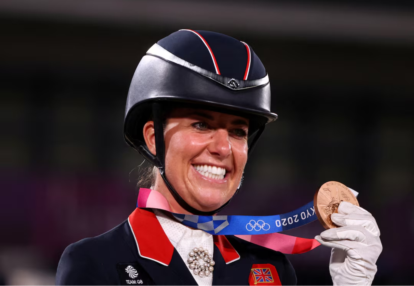 Charlotte Dujardin of the United Kingdom poses with her team dressage bronze medal at the Tokyo Summer Olympics in Tokyo, Japan, July 27, 2021. /Reuters