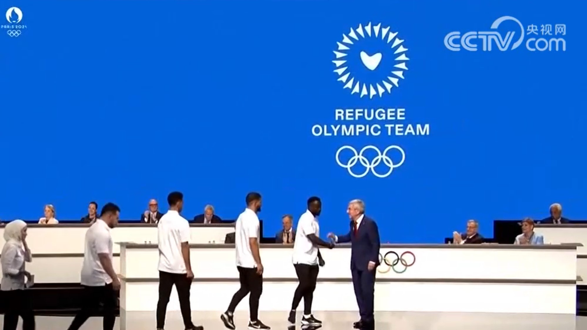 Thomas Bach (R), President of the International Olympic Committee (IOC), shakes hands with representatives of the Refugee Olympic Team at the 142nd IOC session in Paris, France, July 23, 2024. /CMG