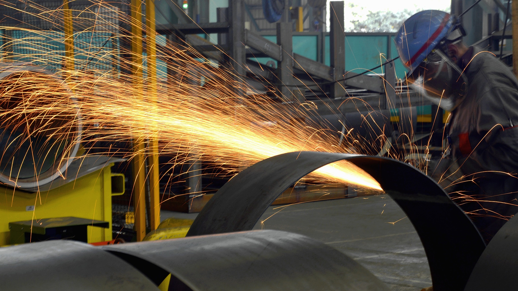 Workers welding industrial order products in Wuxi, Jiangsu Province, China, March 29, 2022. /CFP