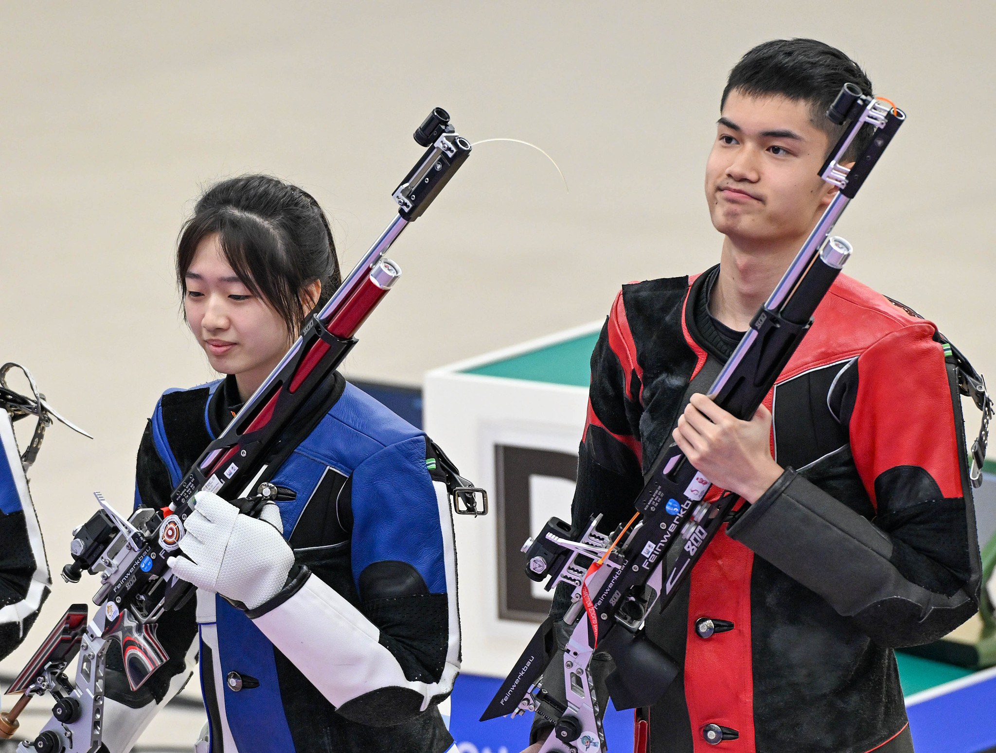 Huang Yuting (L) and Sheng Lihao of China look on during the 10-meter air rifle mixed team final at the 19th Asian Games in Hangzhou, east China's Zhejiang Province, September 26, 2023. /CFP