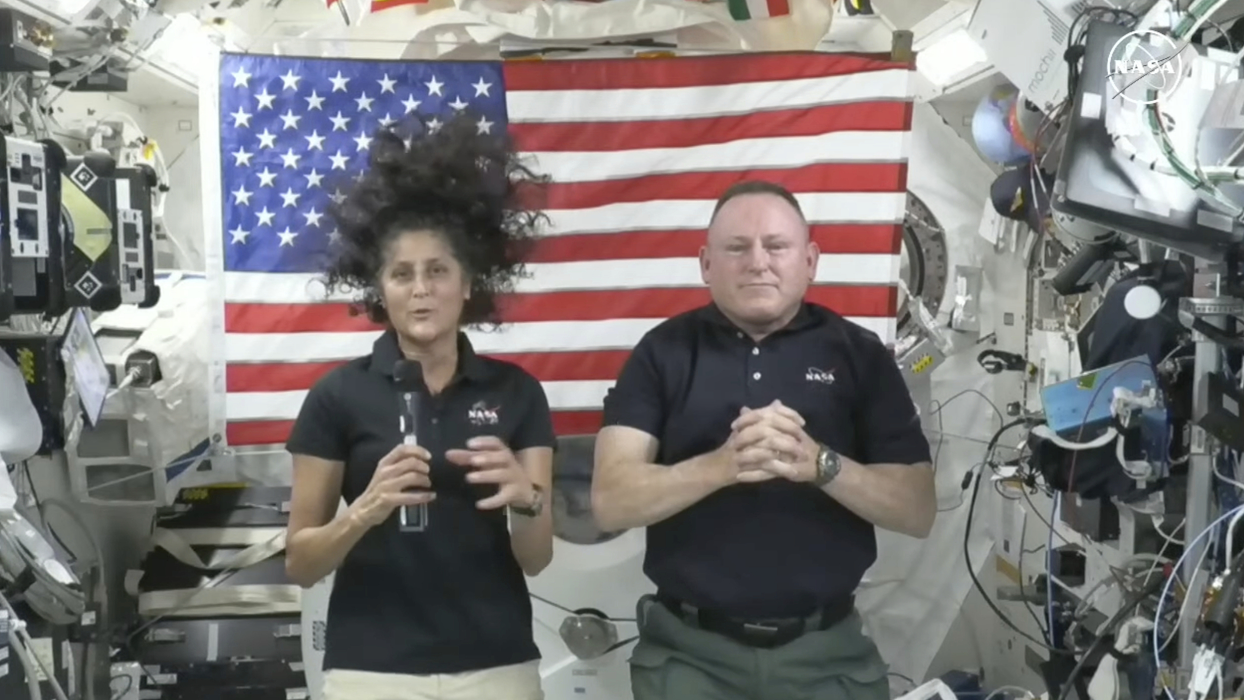Astronauts Suni Williams, left, and Butch Wilmore, right, give a news conference aboard the International Space Station on July 10, 2024. /CFP