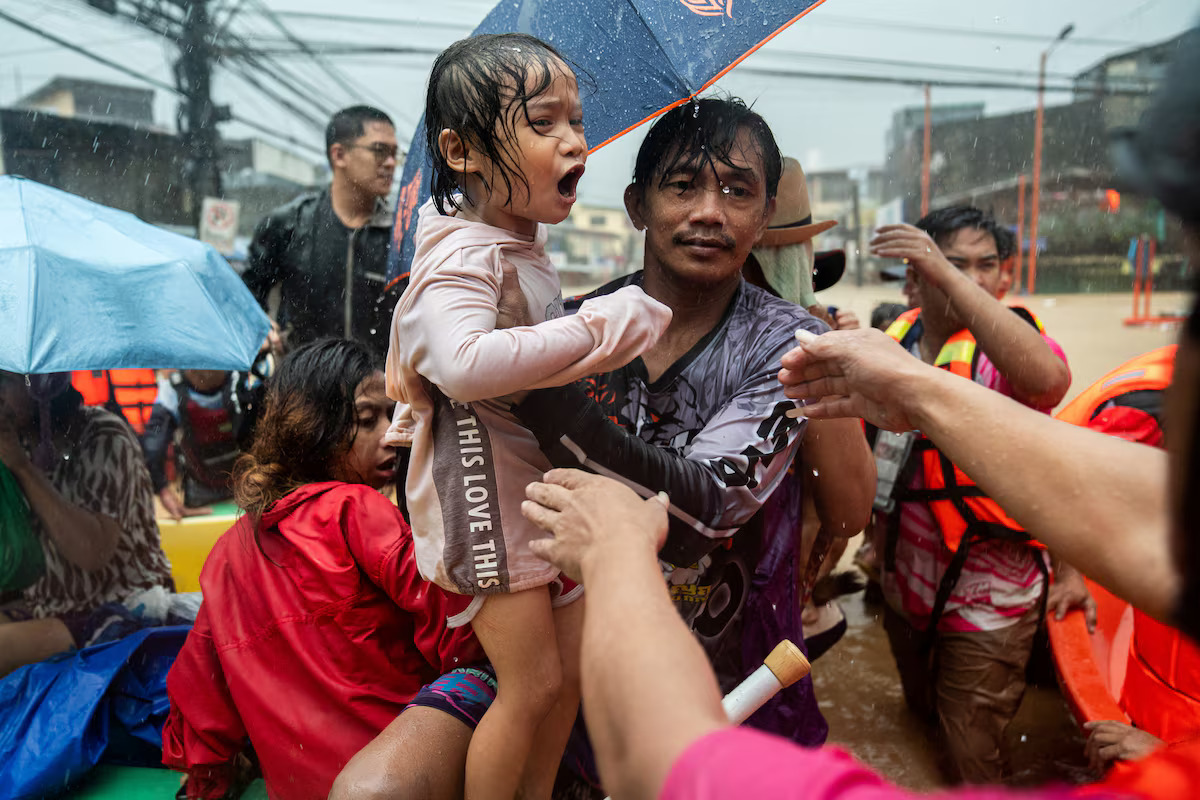 Rescuers assist a child getting off a boat along a flooded road following heavy rains brought by Typhoon Gaemi, in Marikina City, Metro Manila, Philippines, July 24, 2024. /Reuters