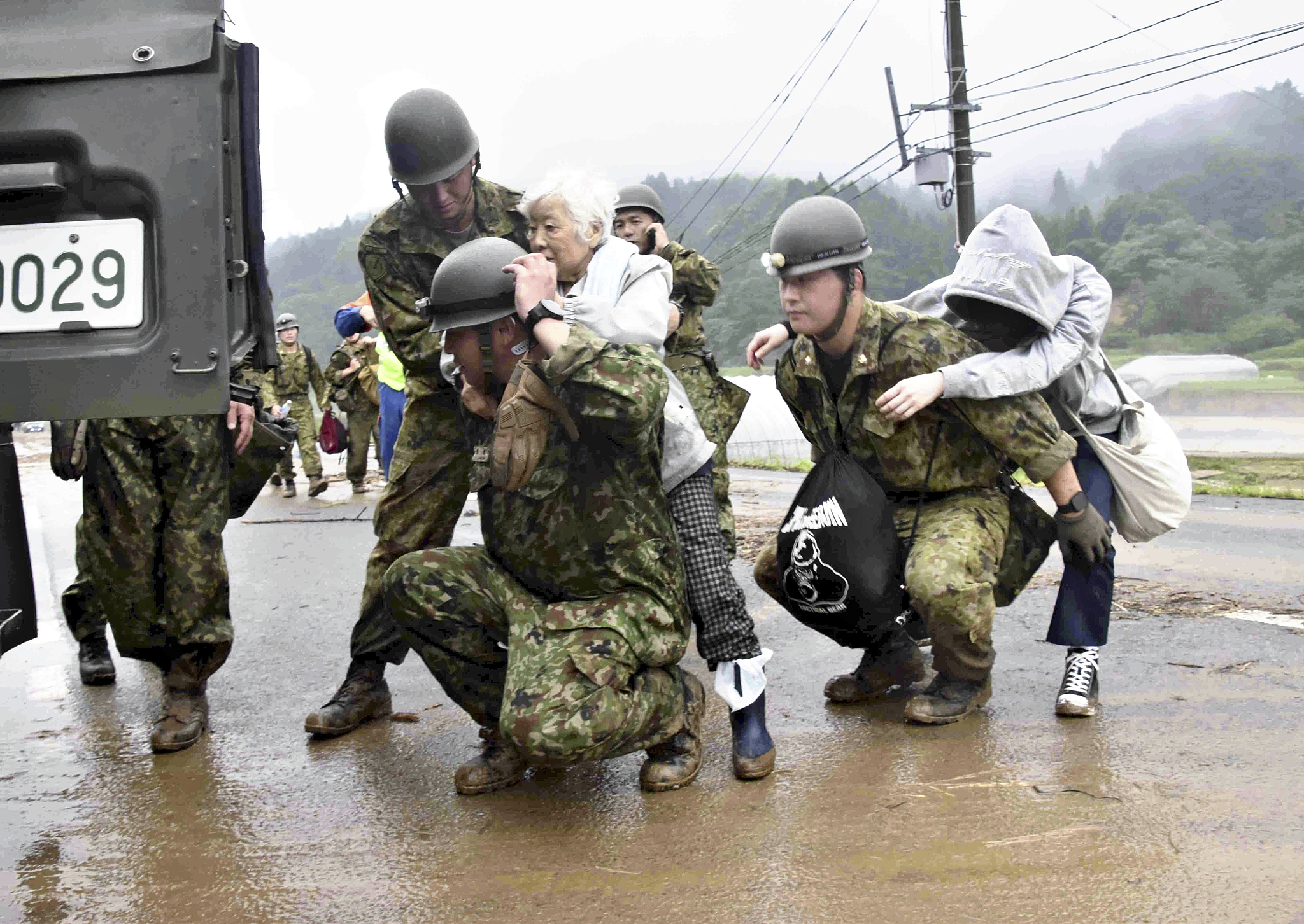 Japan's Self-Defense Force members rescue residents in Sakata City, Yamagata Prefecture, Japan, July 26, 2024. /CFP