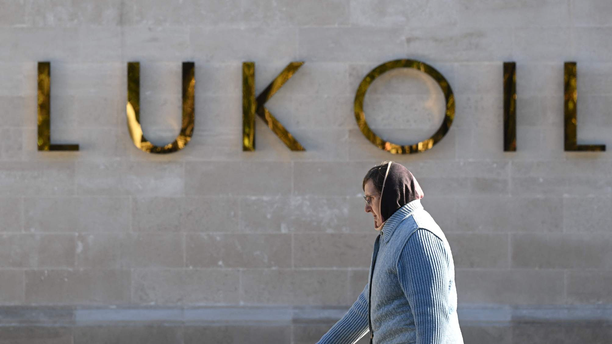 A woman walks past the headquarters of Russia's oil producer Lukoil in Moscow on October 10, 2022. /CFP