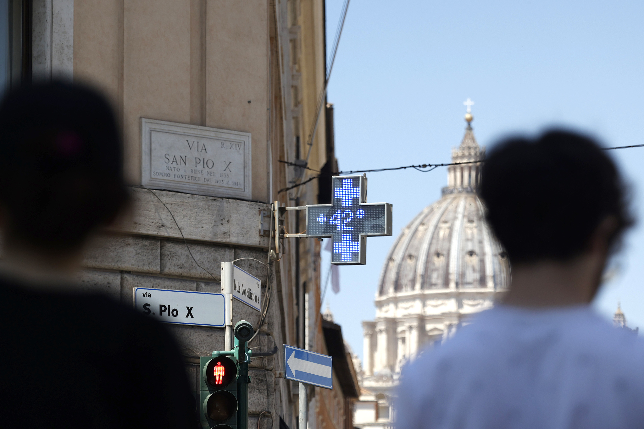 A pharmacy's signboard shows the external temperature as St. Peter's Dome is seen in background during an intensely hot day in Rome, Italy, July 11, 2024. /CFP 