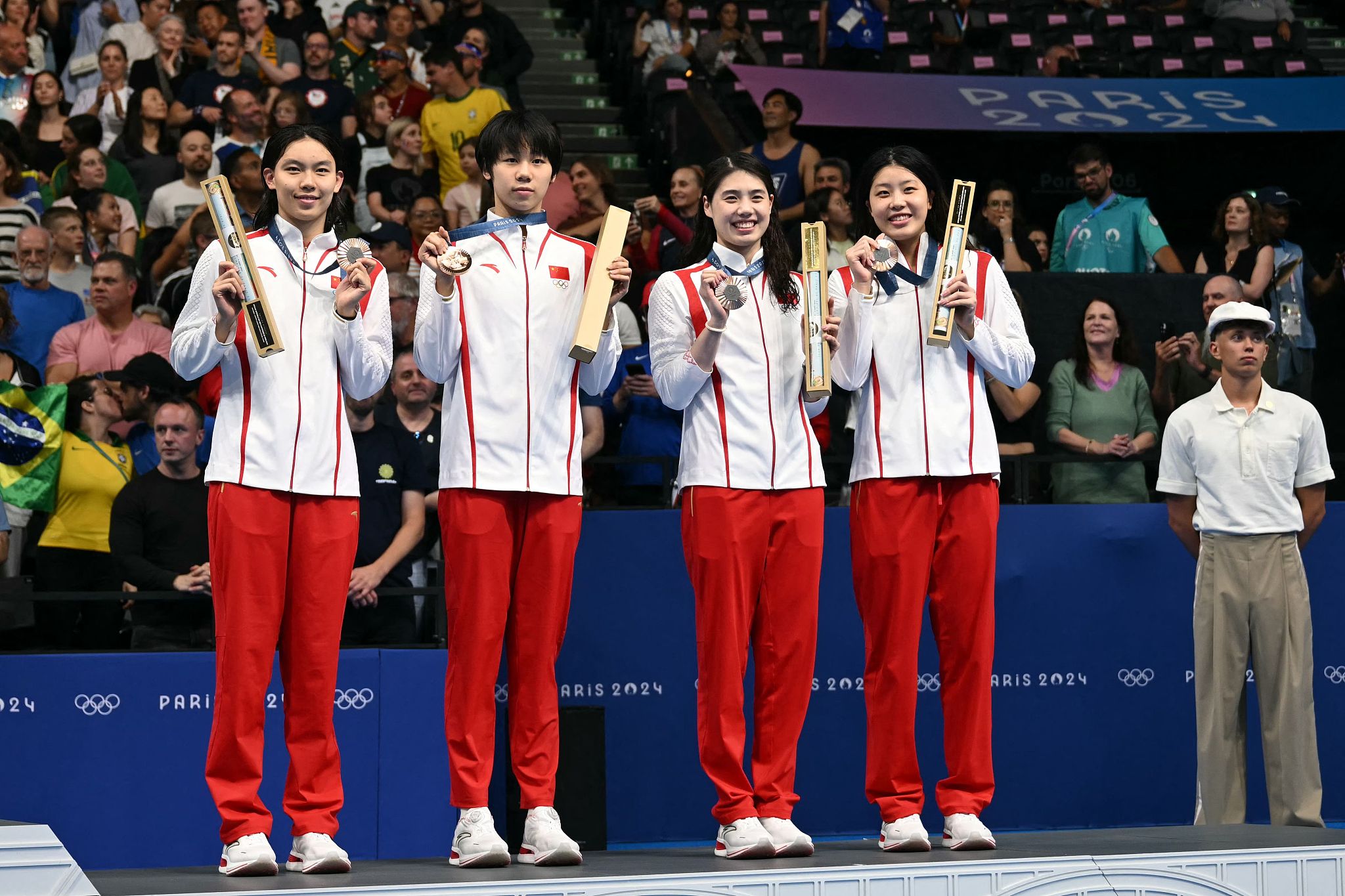 L-R: Yang Junxuan, Cheng Yujie, Zhang Yufei and Wu Qingfeng of China earn bronze in the women's swimming 4×100-meter freestyle relay at the 2024 Summer Olympics in Paris, France, July 27, 2024. /CFP