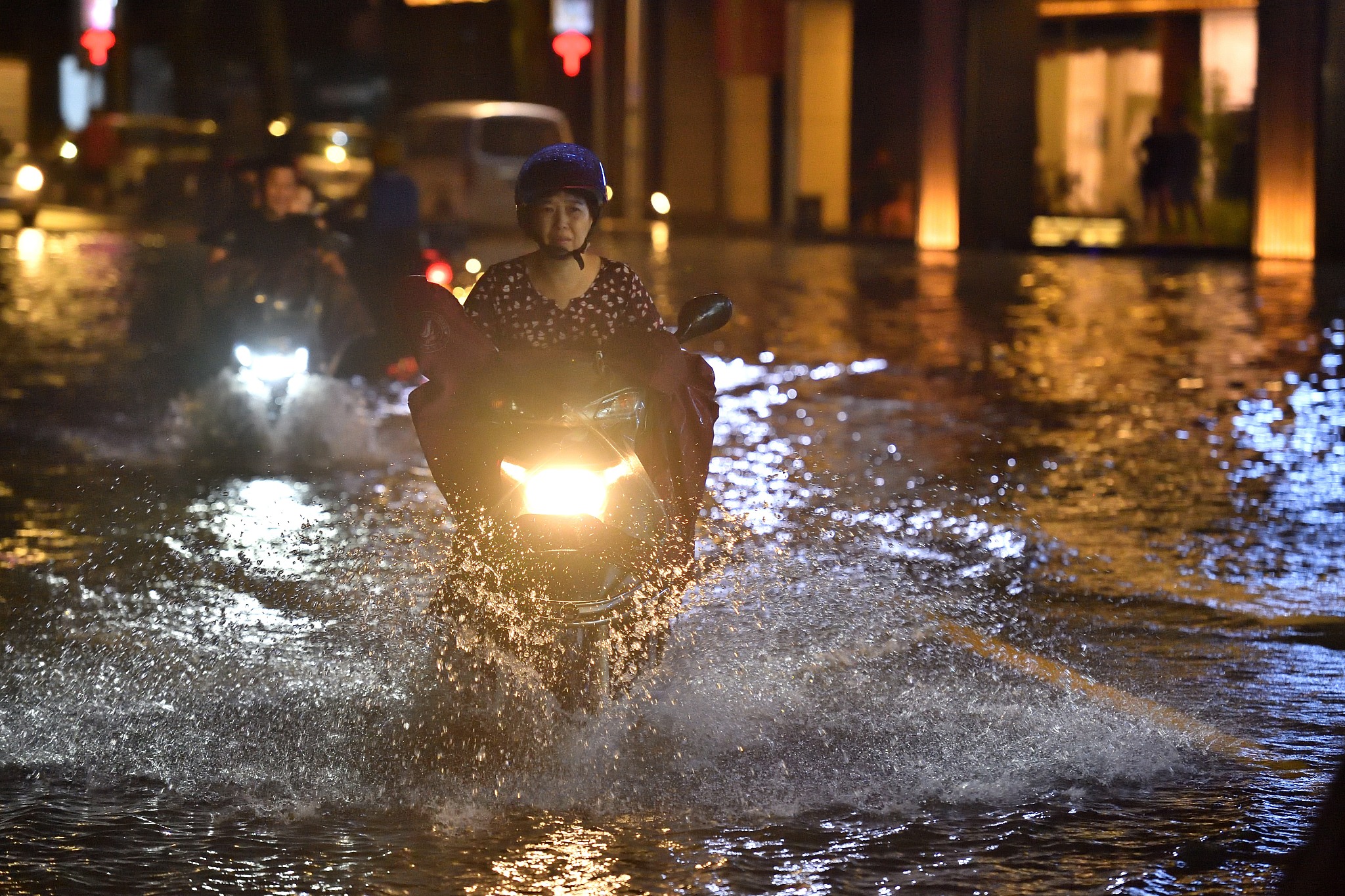 A resident wades through a flooded street on a motorbike after Typhoon Gaemi brought heavy rain to Chaozhou City, Guangdong Province, south China, July 26, 2024. /CFP