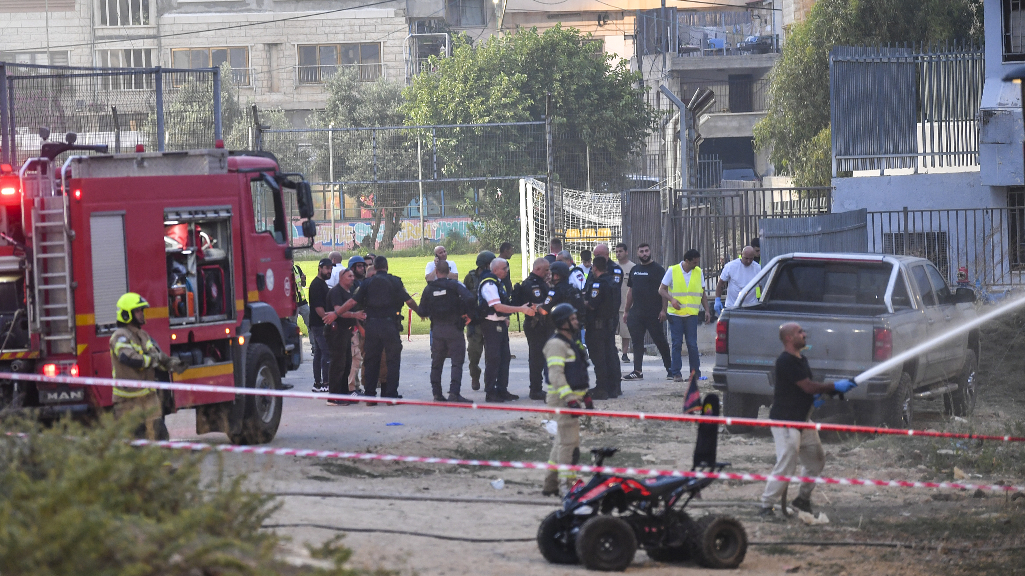 Israeli police officers and firefighters work at the site of a rocket attack in Majdal Shams, in the Israeli-controlled Golan Heights, July 27, 2024. /CFP