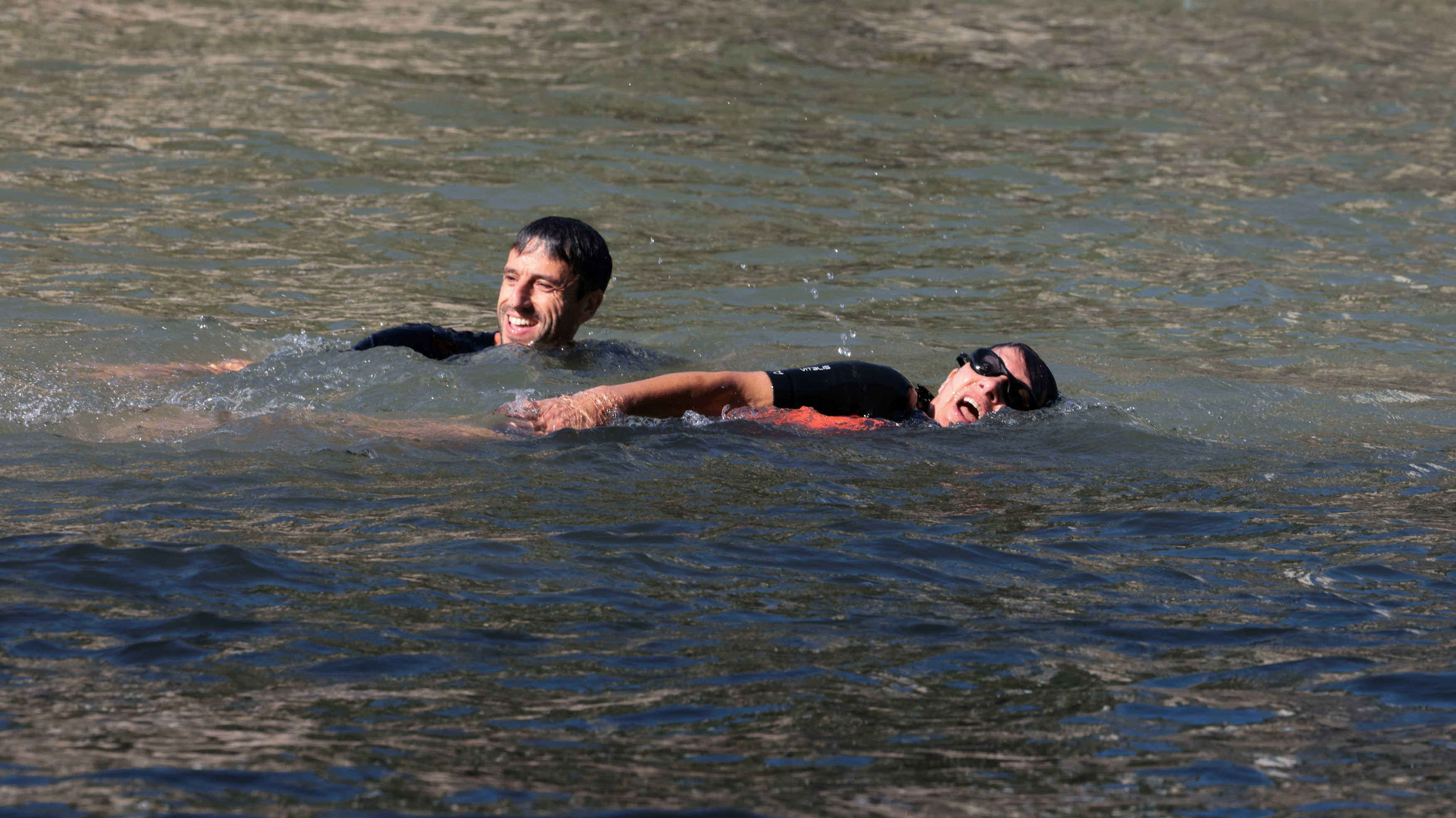 Paris Mayor Anne Hidalgo and President of the Paris 2024 Olympics and Paralympics Organizing Committee Tony Estanguet swim in the Seine to demonstrate that the river is clean enough to host the outdoor swimming events at the Paris Olympics, in Paris, France, July 17, 2024. /Reuters