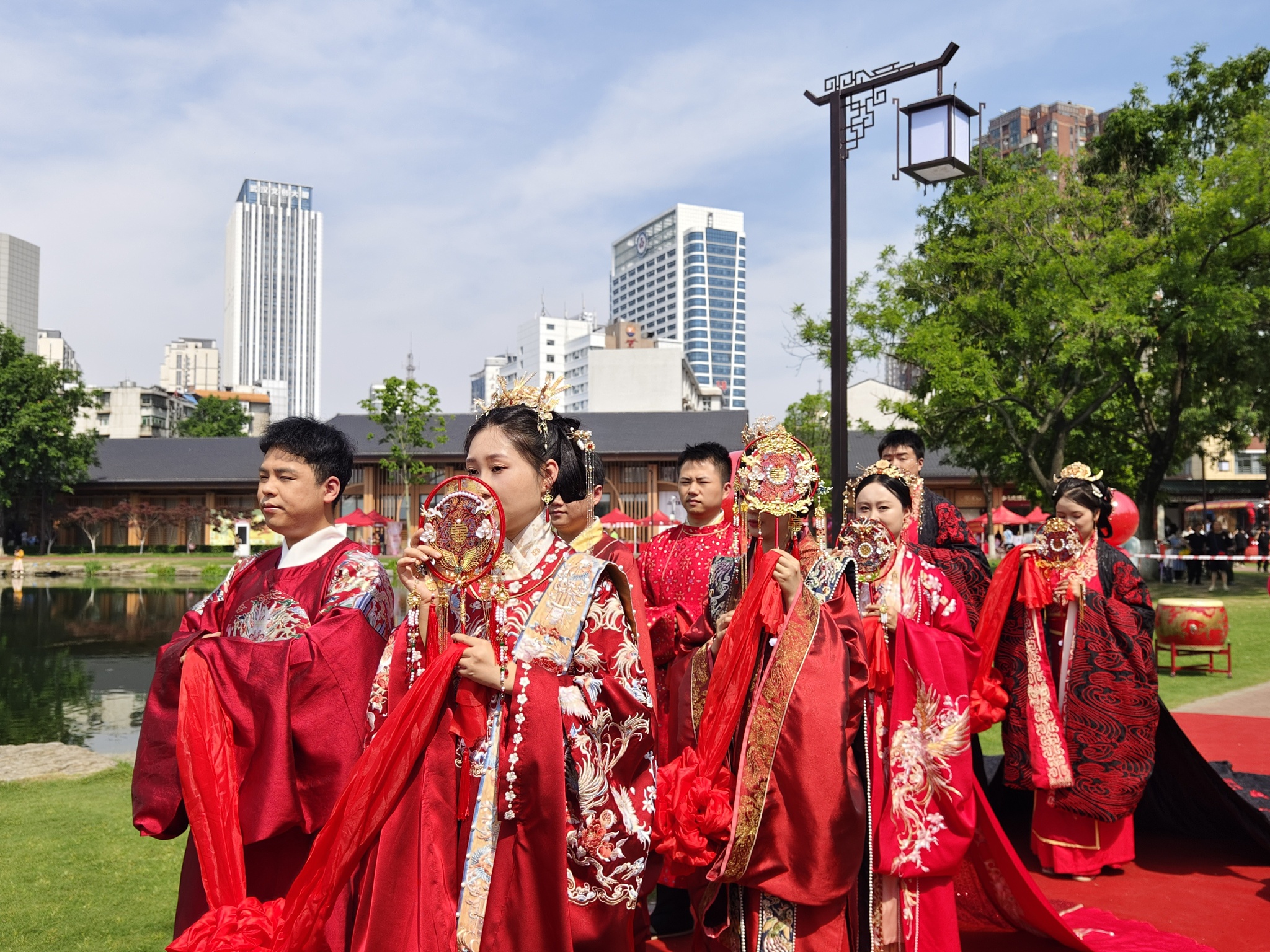 Newlyweds dressed in traditional costumes attend a group wedding at Ziyang Park in Wuhan, central China's Hubei Province, May 18, 2024. /CFP