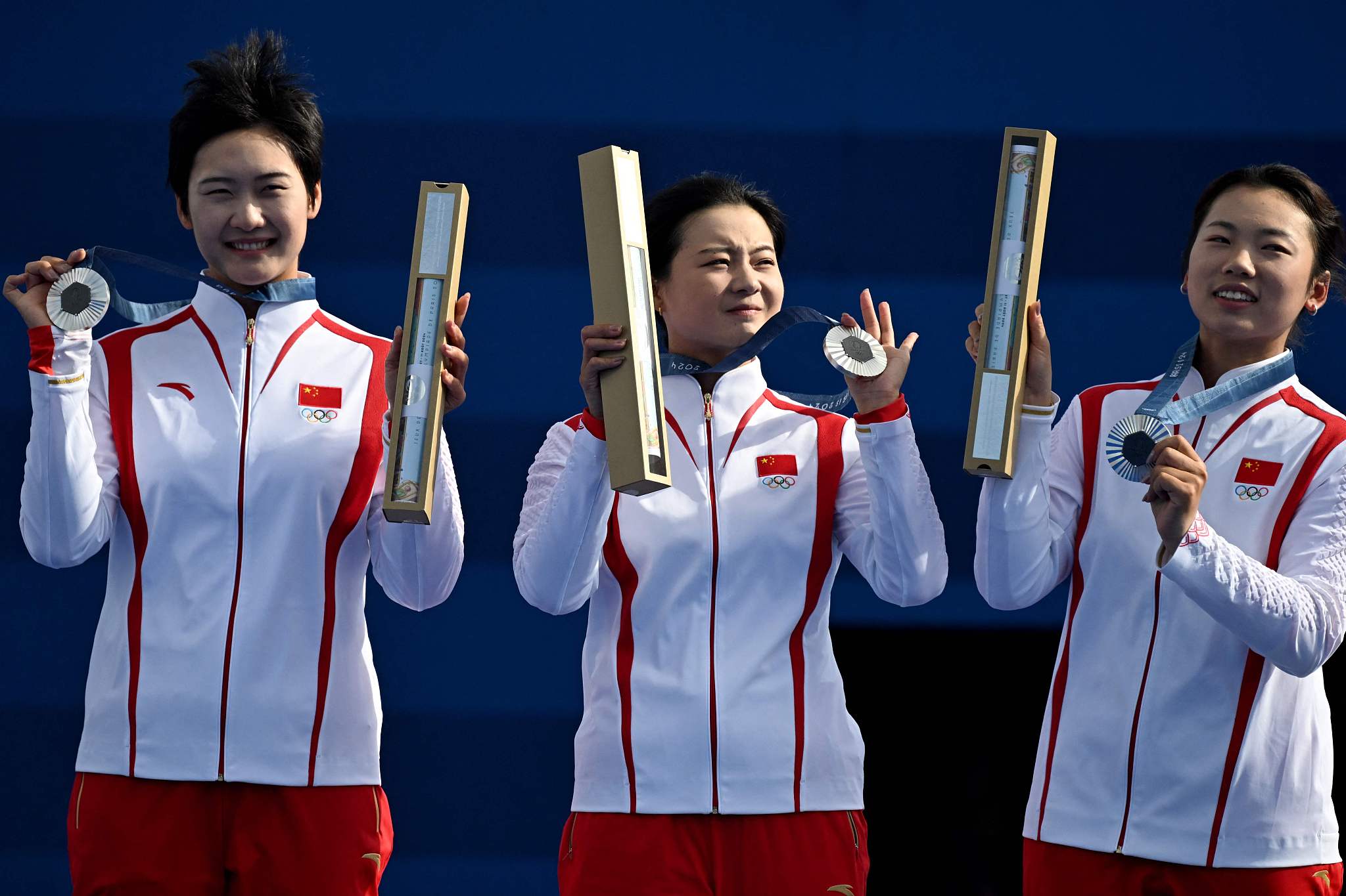 L-R: An Qixuan, Li Jiaman and Yang Xiaolei of China secure the women's archery team silver medal at the 2024 Summer Olympic Games in Paris, July 28, 2024. /CFP