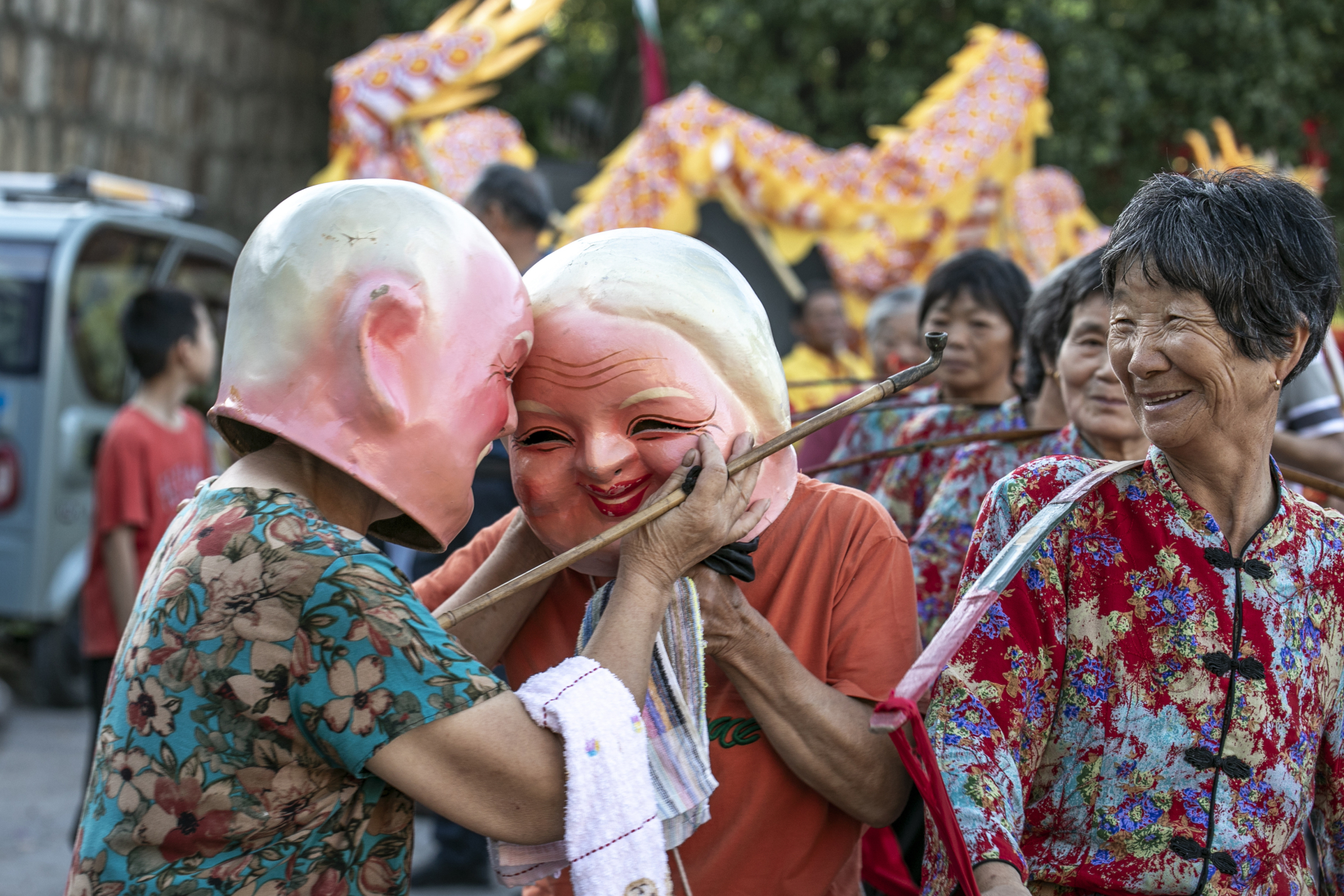 Villagers wearing masks enjoy the Lotus Festival in Suzhou, Jiangsu Province on July 29, 2024. /CFP