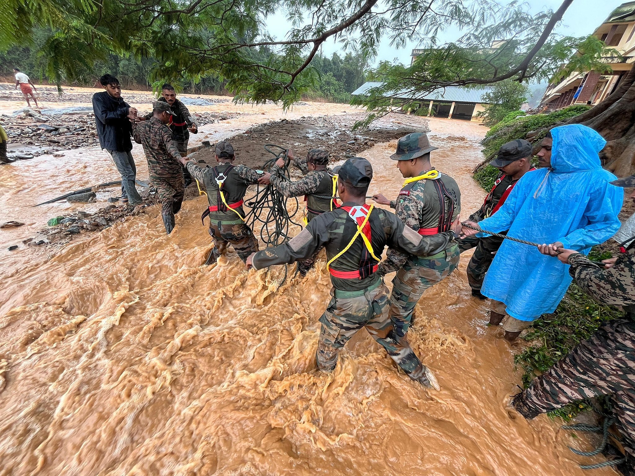 Army officials, emergency teams and civilians help rescue people at the disaster site where a landslide occurred and destroyed hundreds of houses, resulting in mass fatalities in Wayanad district, Kerala State, India, July 30, 2024. /SOUTHERN COMMAND INDIAN ARMY / HANDOUT