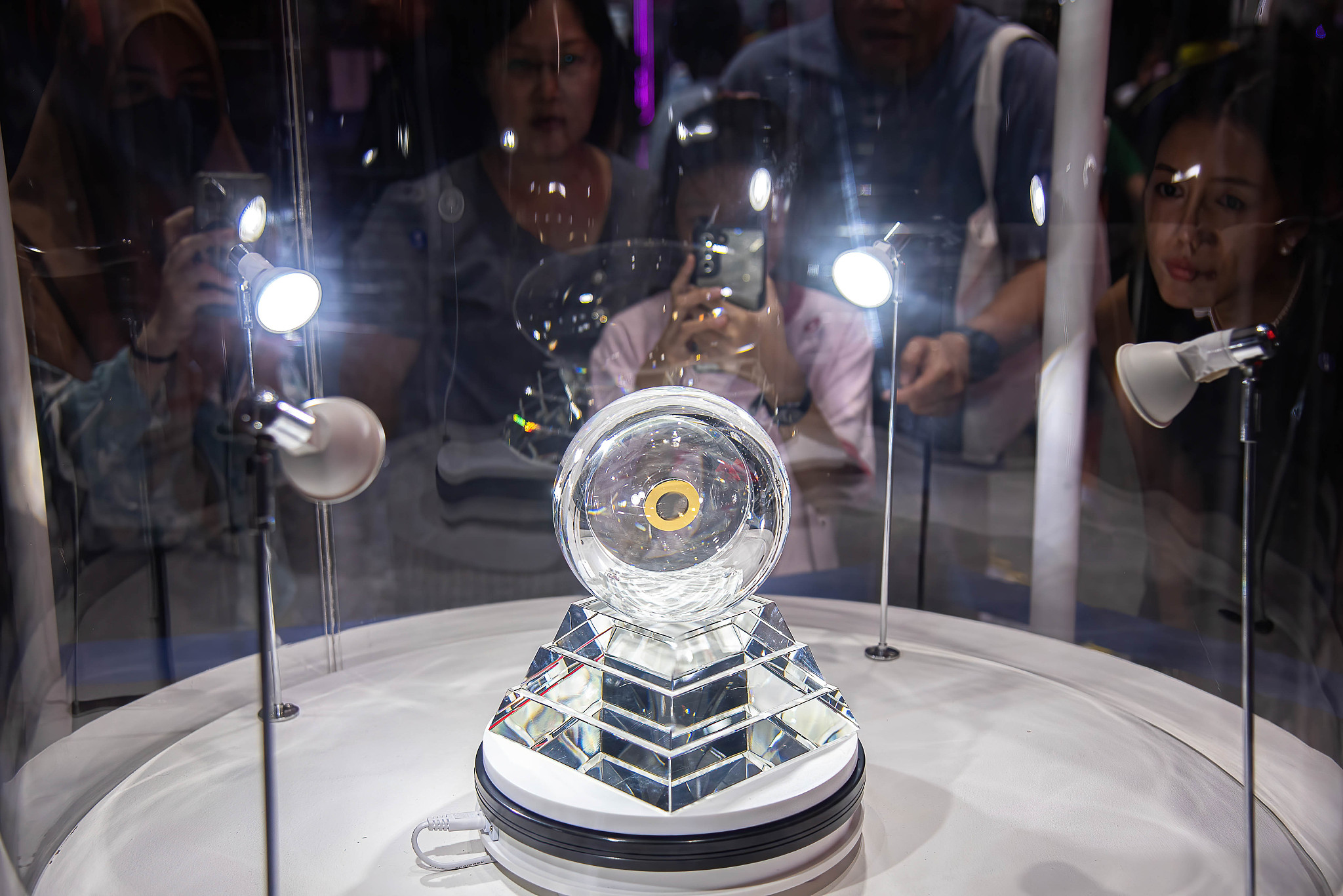 Visitors check out the lunar sample retrieved by China's Chang'e 5 spacecraft displayed at Sci Power for Future Thailand Fair in Thailand, July 27, 2024. /CFP