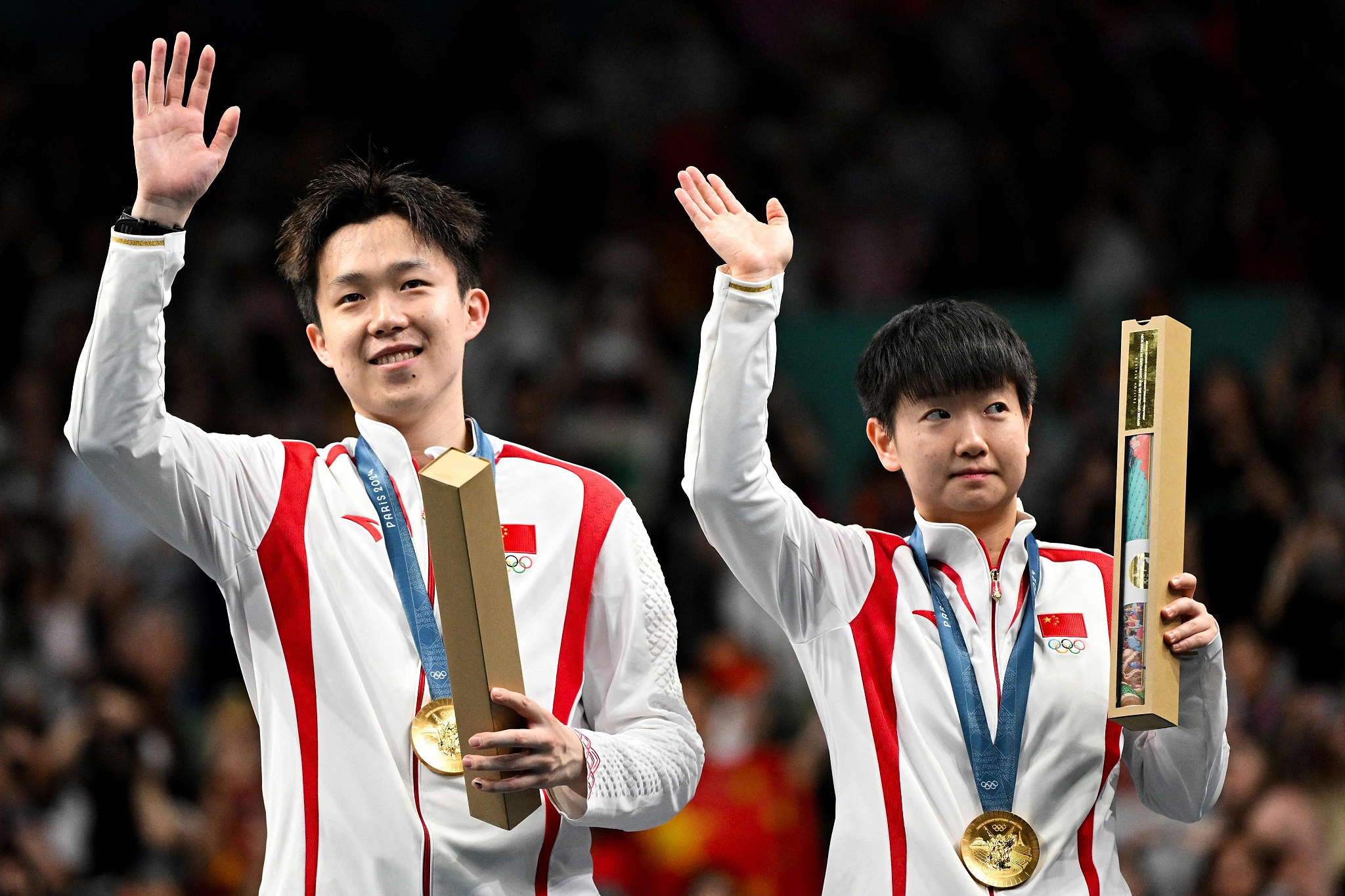 Wang Chuqin (L) and Sun Yingsha of China win the mixed doubles table tennis gold medal at the 2024 Summer Olympic Games in Paris, France, July 30, 2024. /CFP